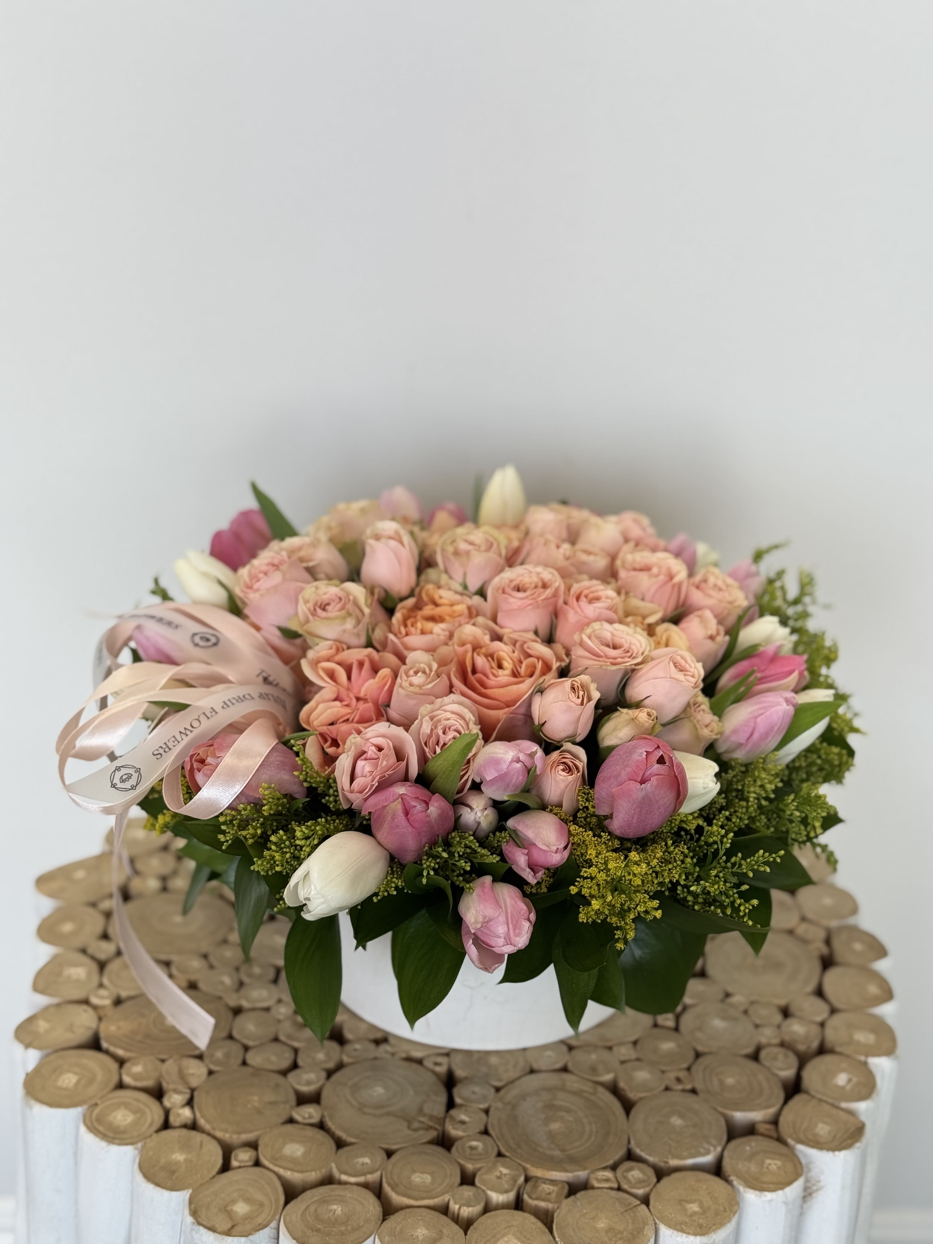Pink and peach rose bouquet in a white box with ribbon
