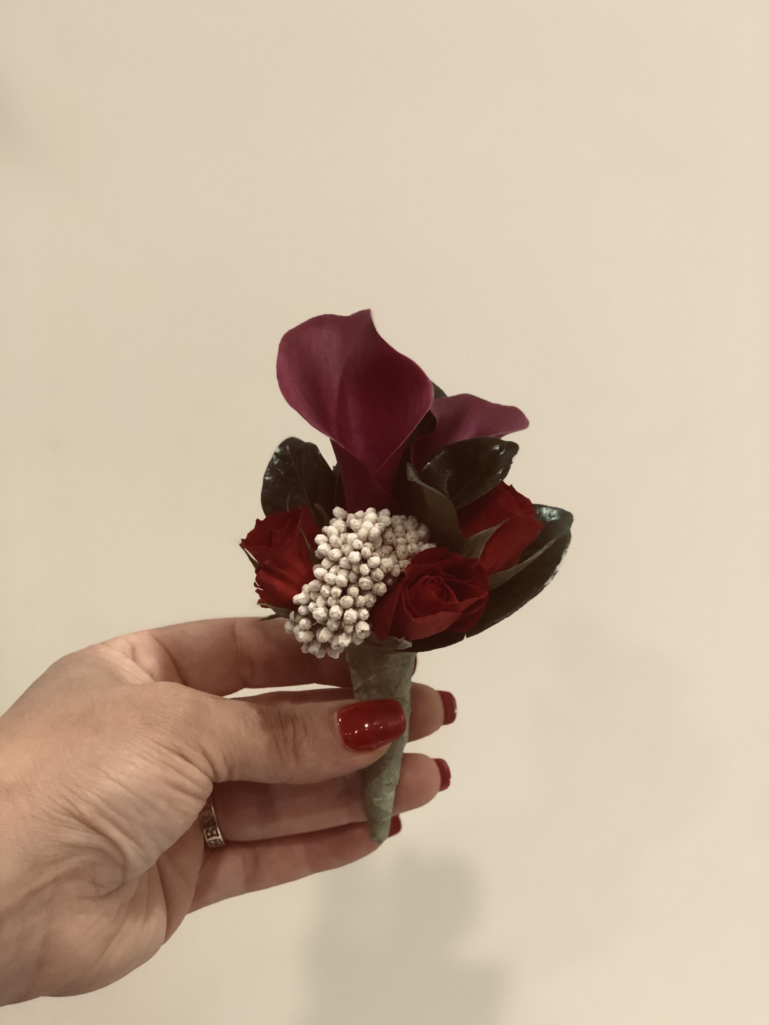 Small burgundy boutonniere with a calla lily and roses