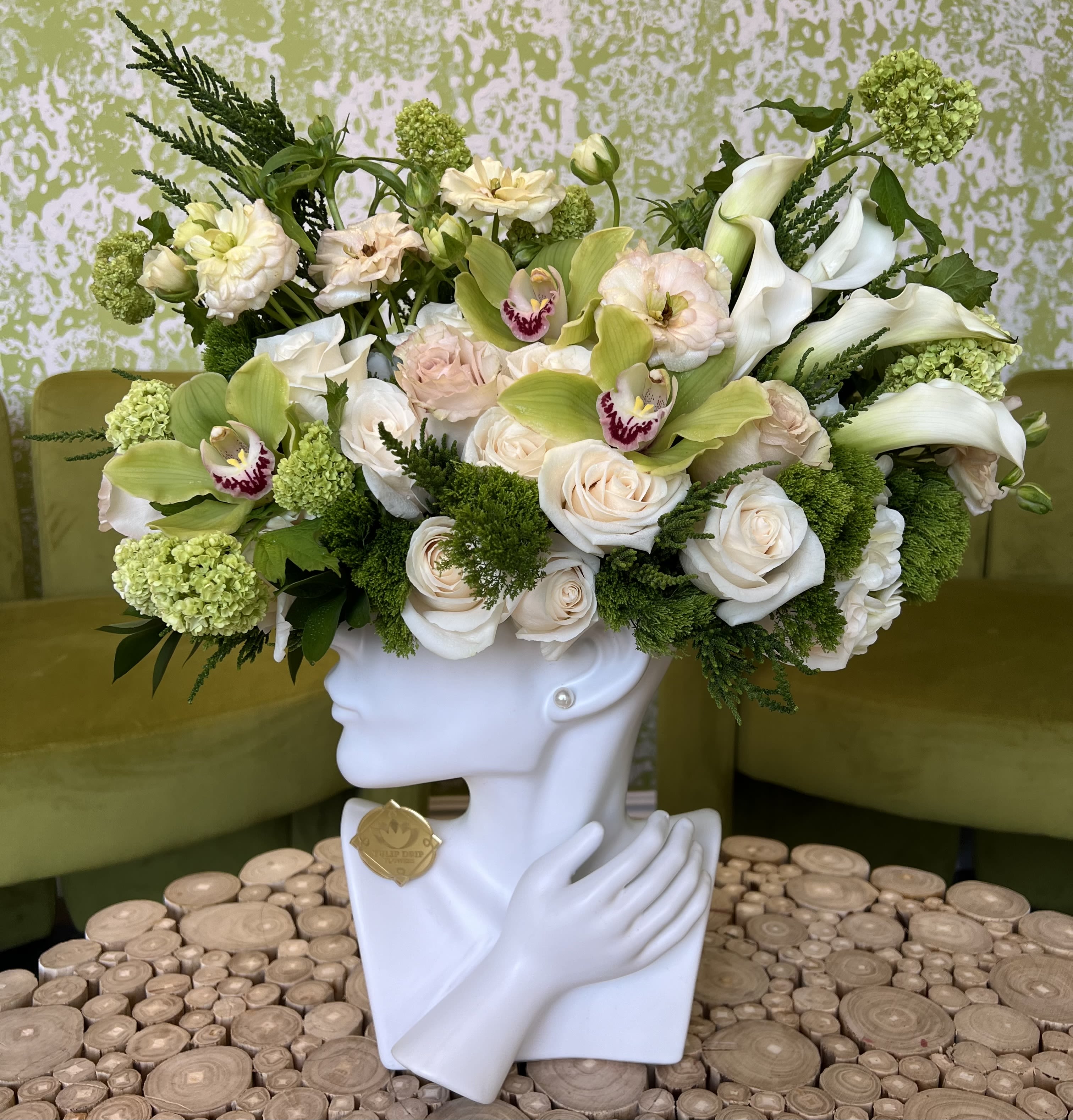 Elegant Lady Green Serenity - A refreshing and sophisticated arrangement of white roses, green cymbidium orchids, and soft greenery. This modern floral design is perfect for the elegant mom who appreciates natural beauty and calm vibes.