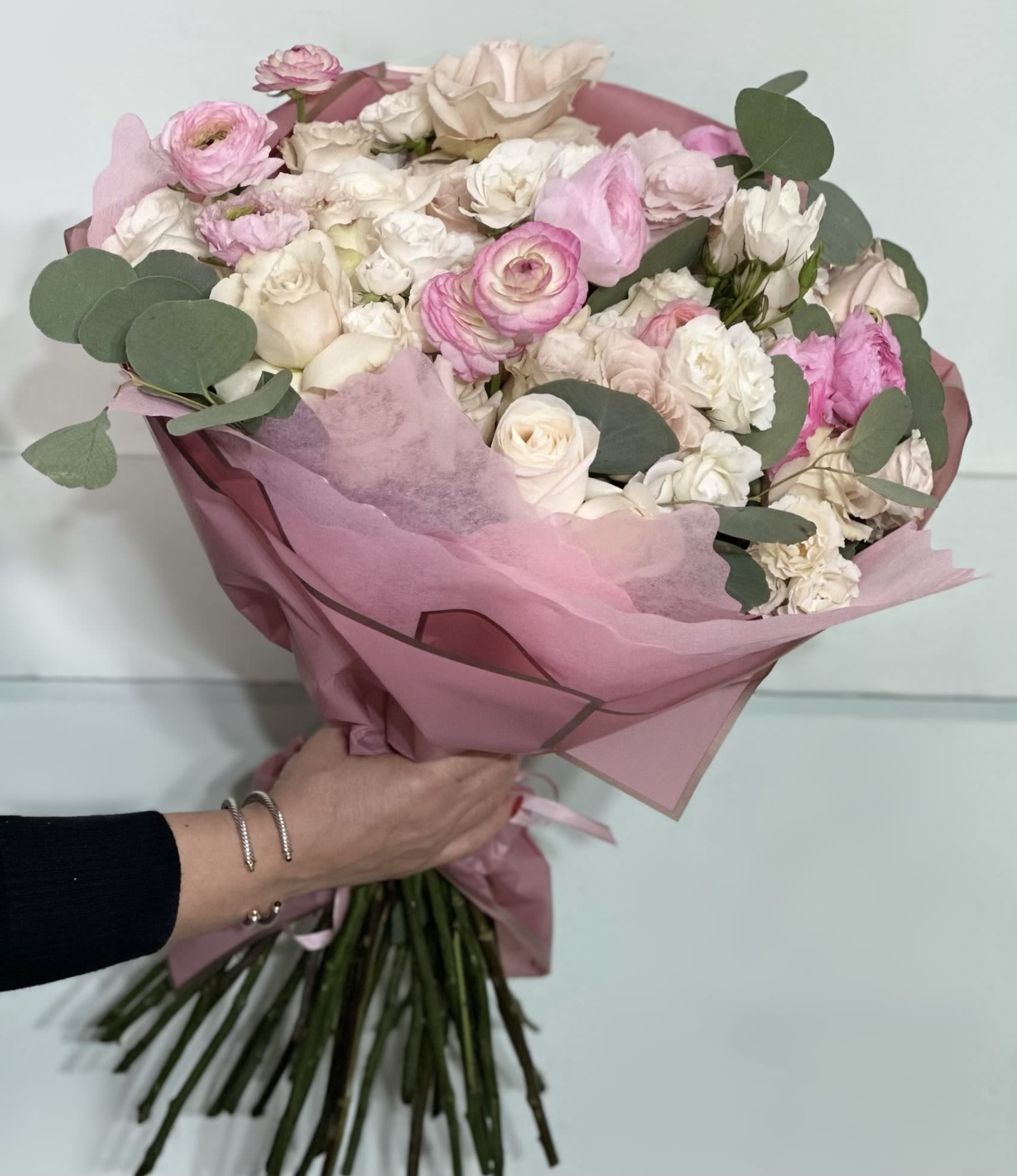 Blush Garden Romance  - Overflowing with ranunculus, lisianthus, and roses in soft pinks and creams, this bouquet is a dreamy celebration of love. Accented with eucalyptus and wrapped in delicate pink, it’s a thoughtful and fresh gift for Valentine’s Day.