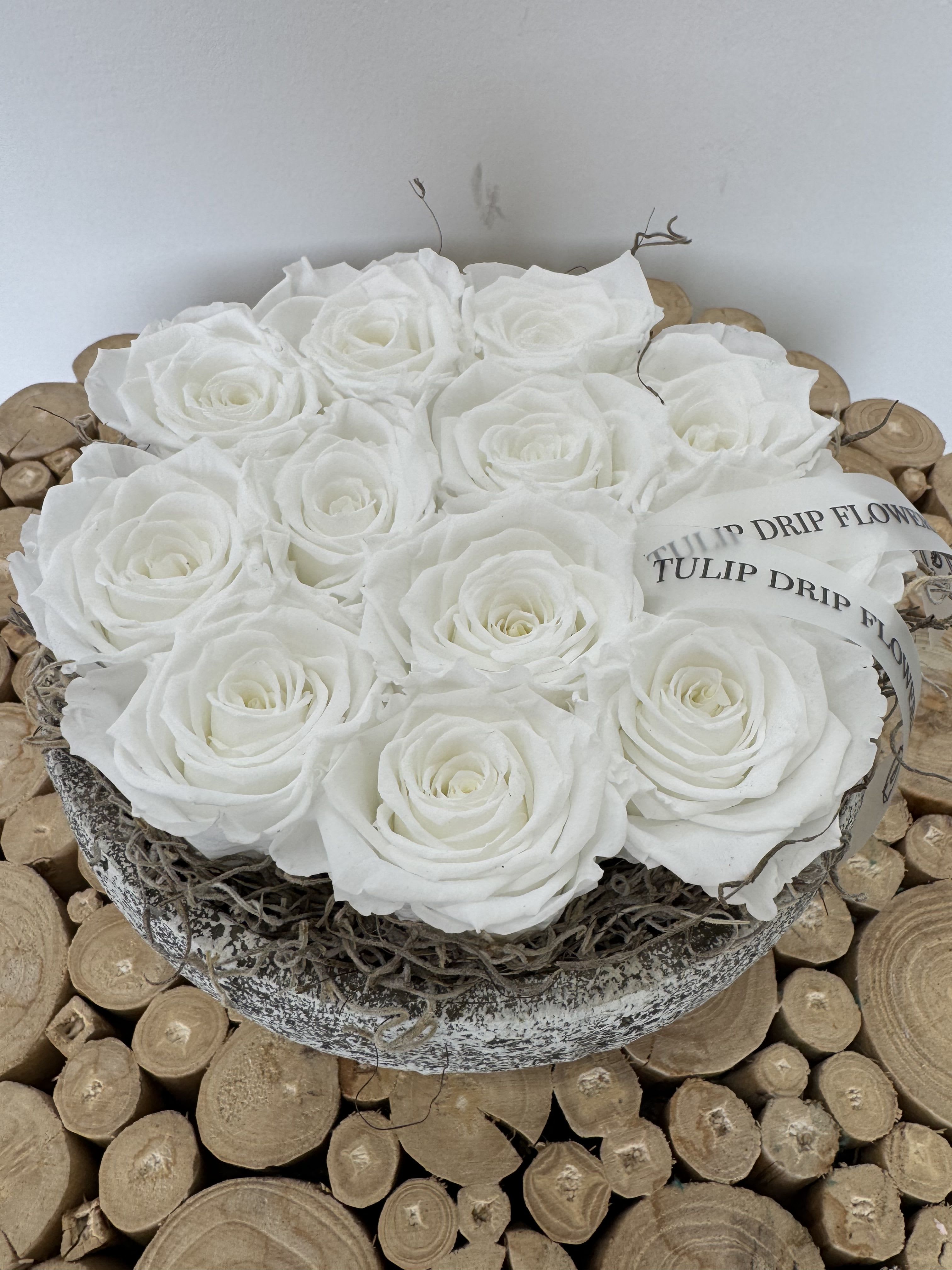 White roses arranged in a round decorative box