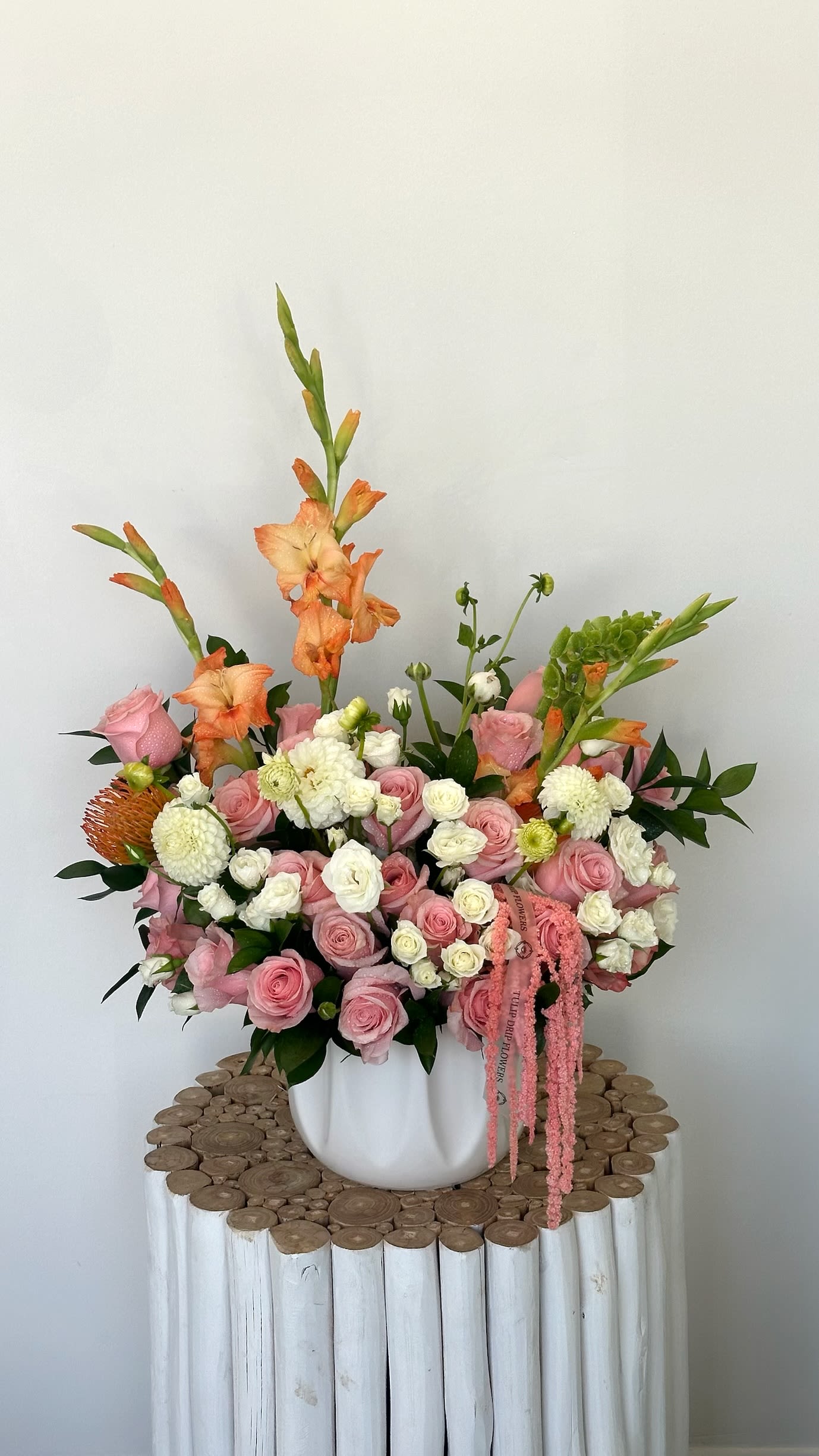 Pink and white floral arrangement in a white vase