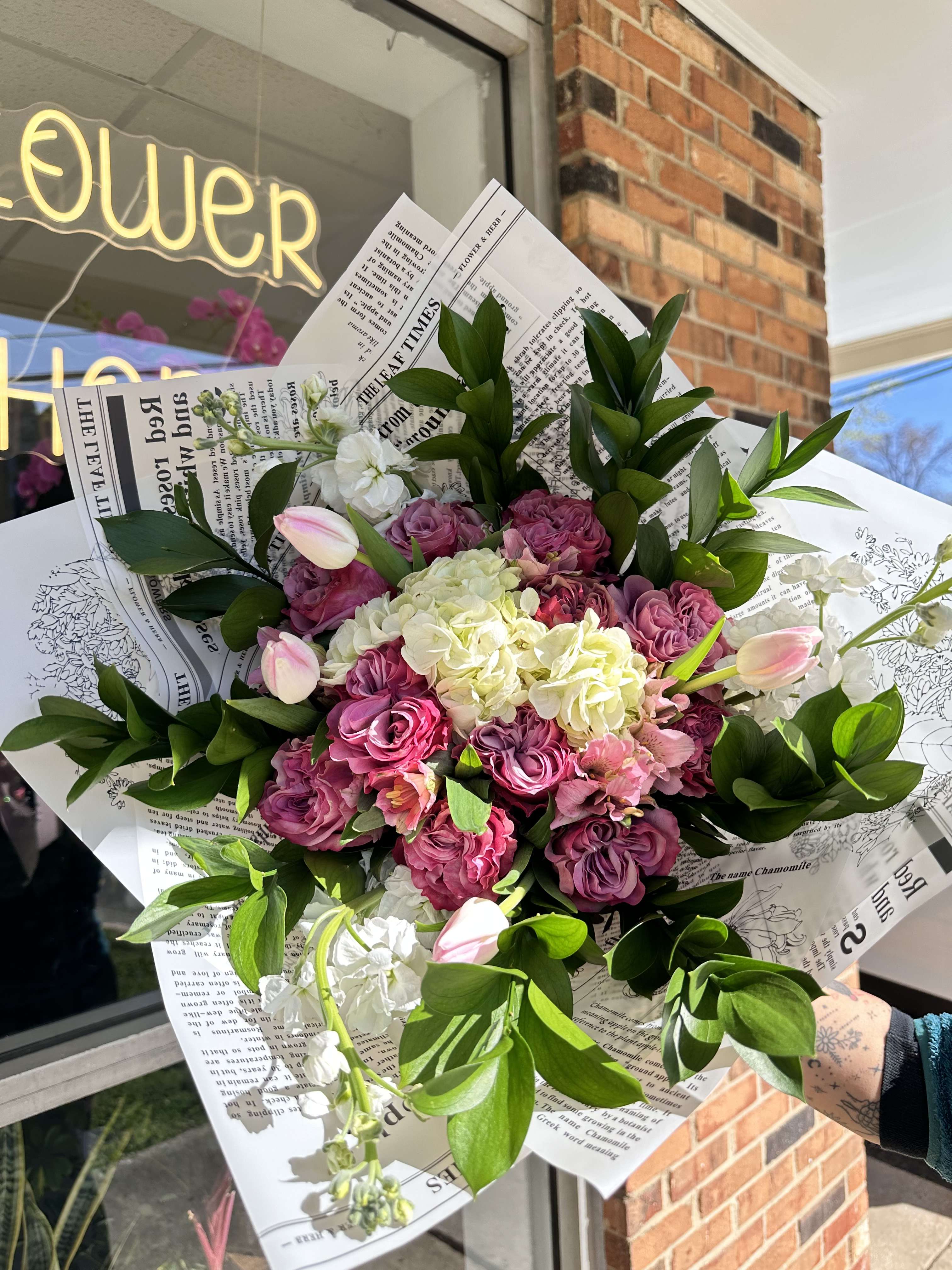 Pink and white bouquet with roses, hydrangea, and tulips in paper wrap