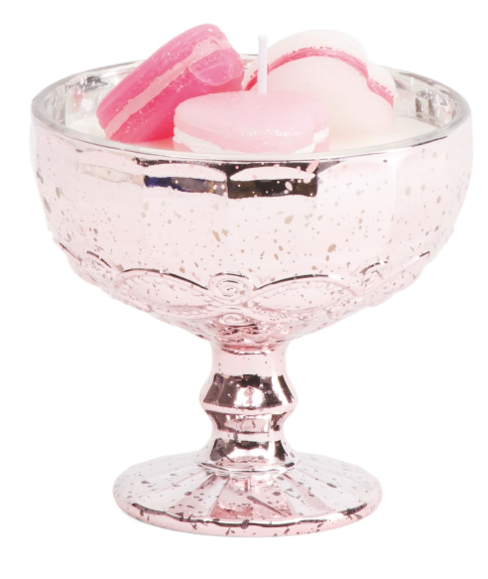 Pink glass pedestal bowl holding pastel macarons