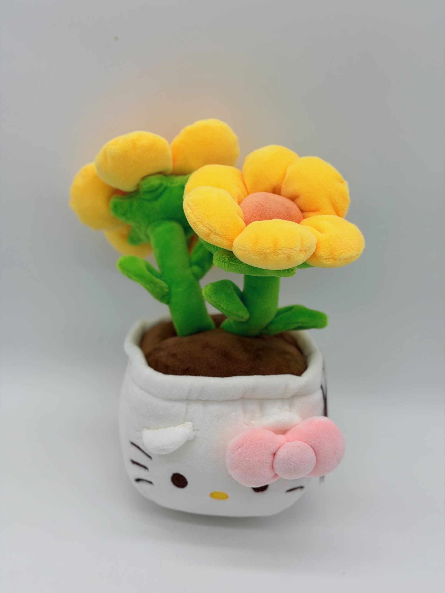 Plush flower arrangement in a Hello Kitty pot with yellow blooms