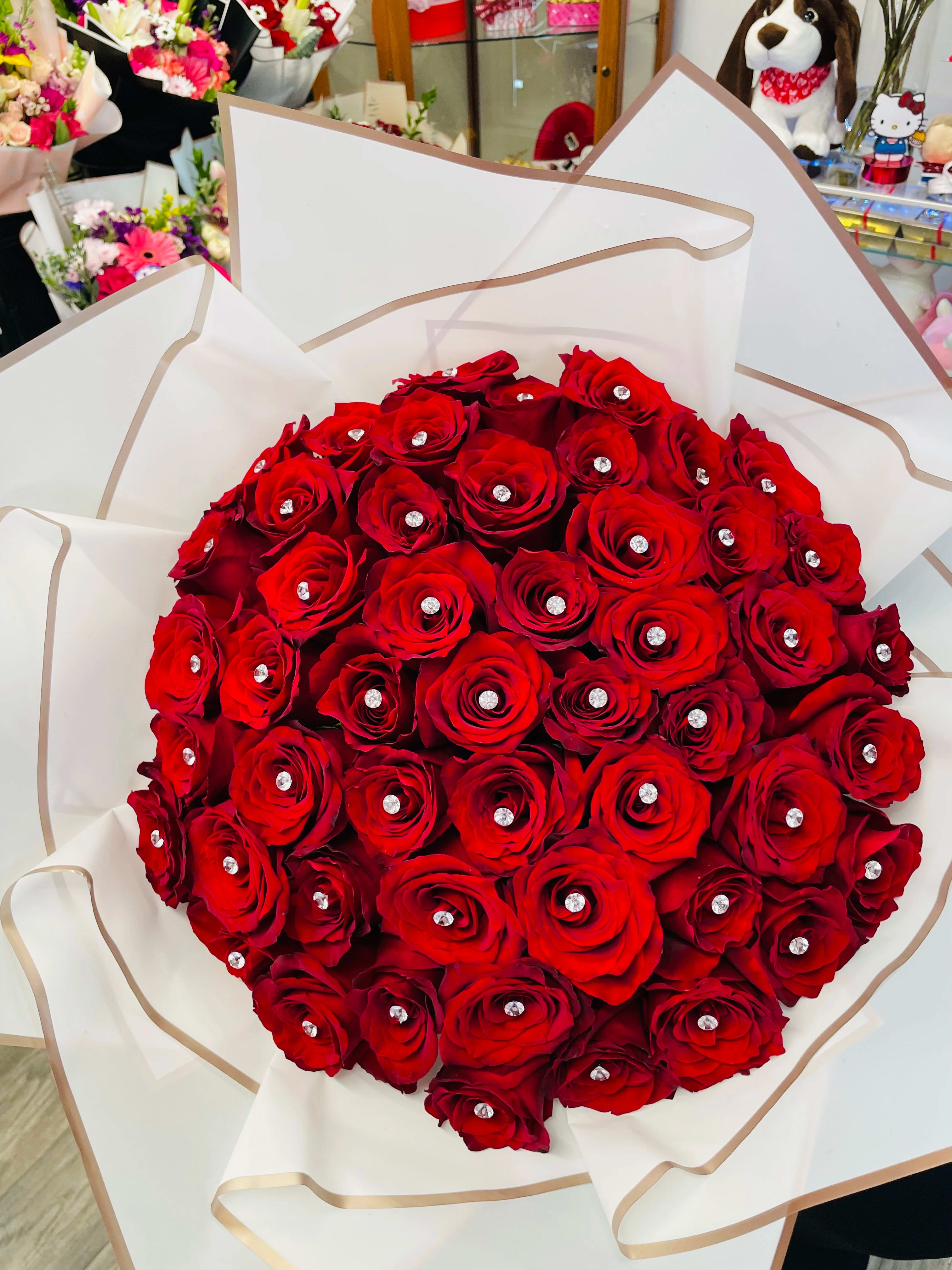 Large bouquet of red roses wrapped in white paper