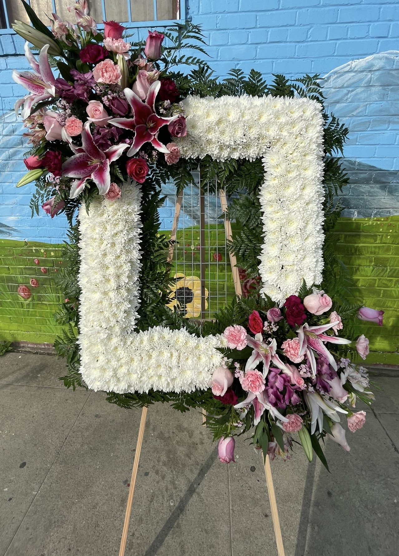 Large floral number-shaped arrangement with white and pink flowers
