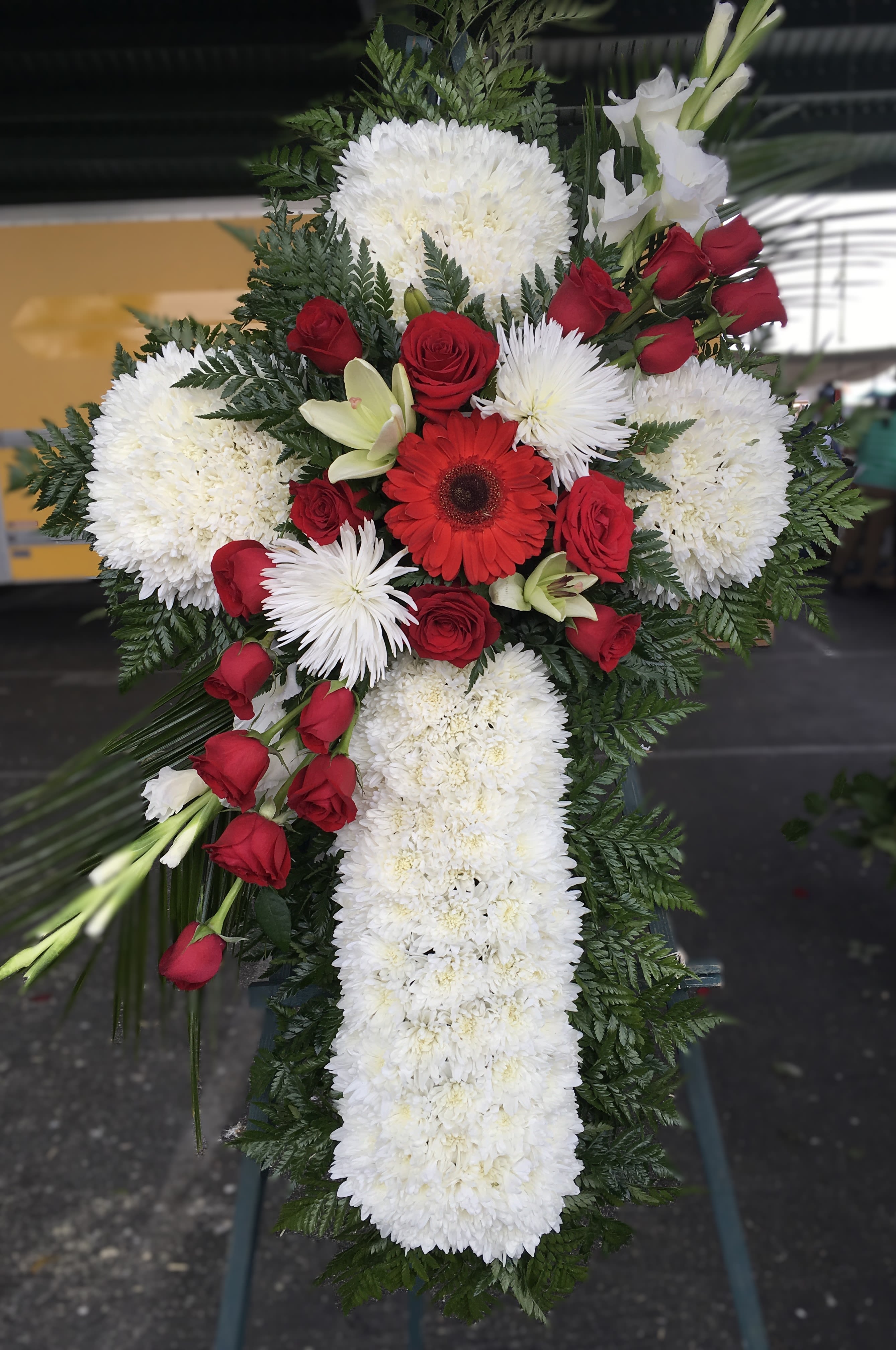 Cross-shaped floral spray with red roses and white chrysanthemums