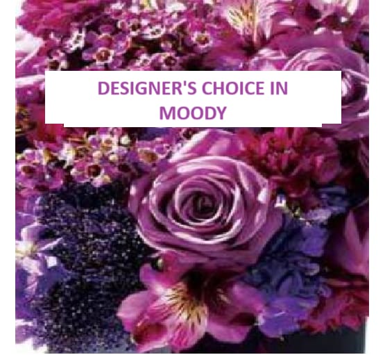 Purple floral arrangement with a large rose and mixed blossoms