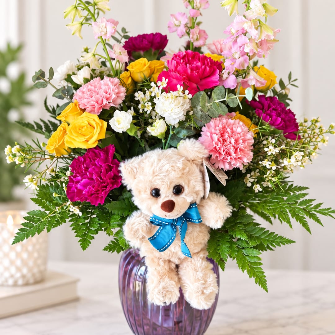 Colorful bouquet with a teddy bear in a purple vase
