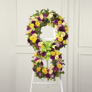The FTD Eternity Standing Easel - The soul&rsquo;s passage into the hereafter is celebrated with this inspiring floral tribute handcrafted by a local FTD artisan florist to reflect the symbol of &ldquo;infinity.&rdquo; The two conjoined wreaths are constructed of yellow roses fuchsia and purple carnations fuchsia dianthus lavender pompons and golden solidago accented with lush greens and trimmed with coordinating ribbon. It&rsquo;s a powerful and lovely statement of faith that is sure to console and comfort all who share your loss.