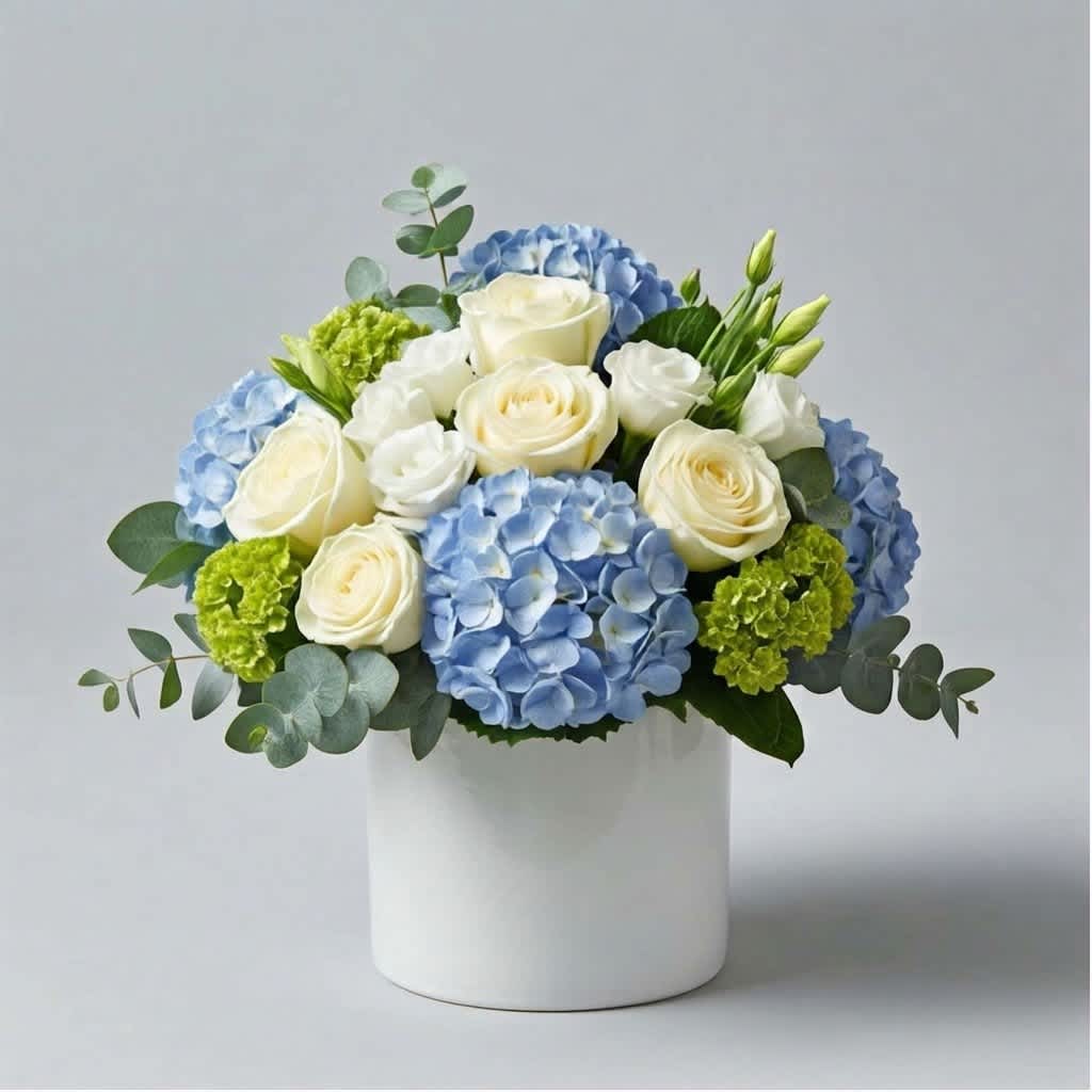Blue hydrangeas and white roses arranged in a white vase