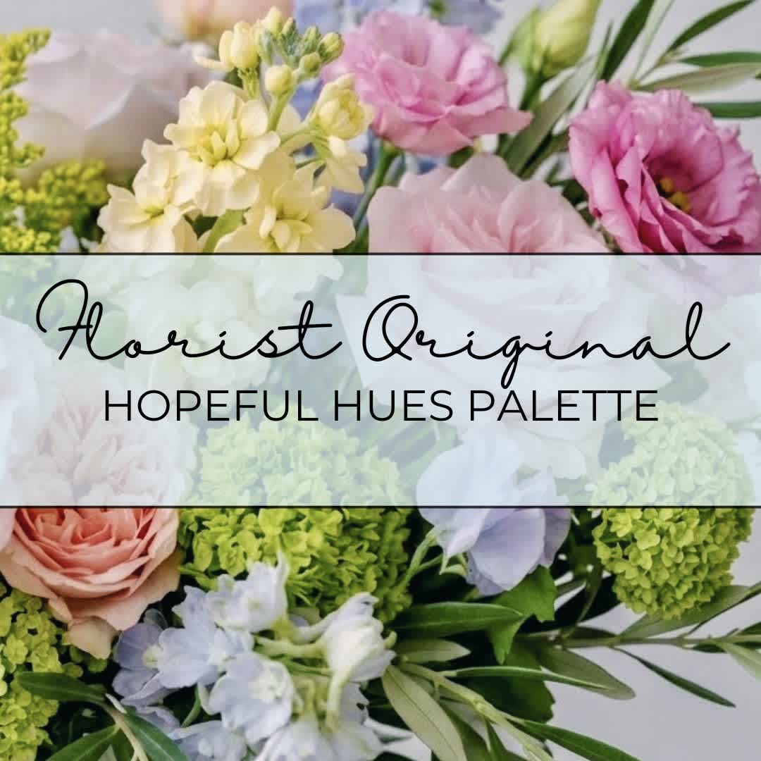 Pastel floral arrangement with pink, cream, and green blooms.