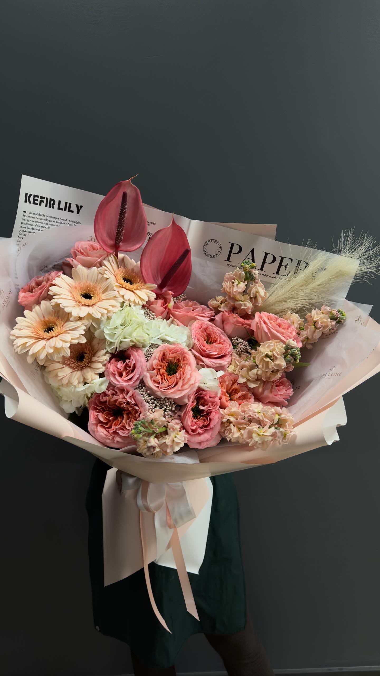 Pink and cream bouquet with gerbera daisies and anthuriums in paper wrap