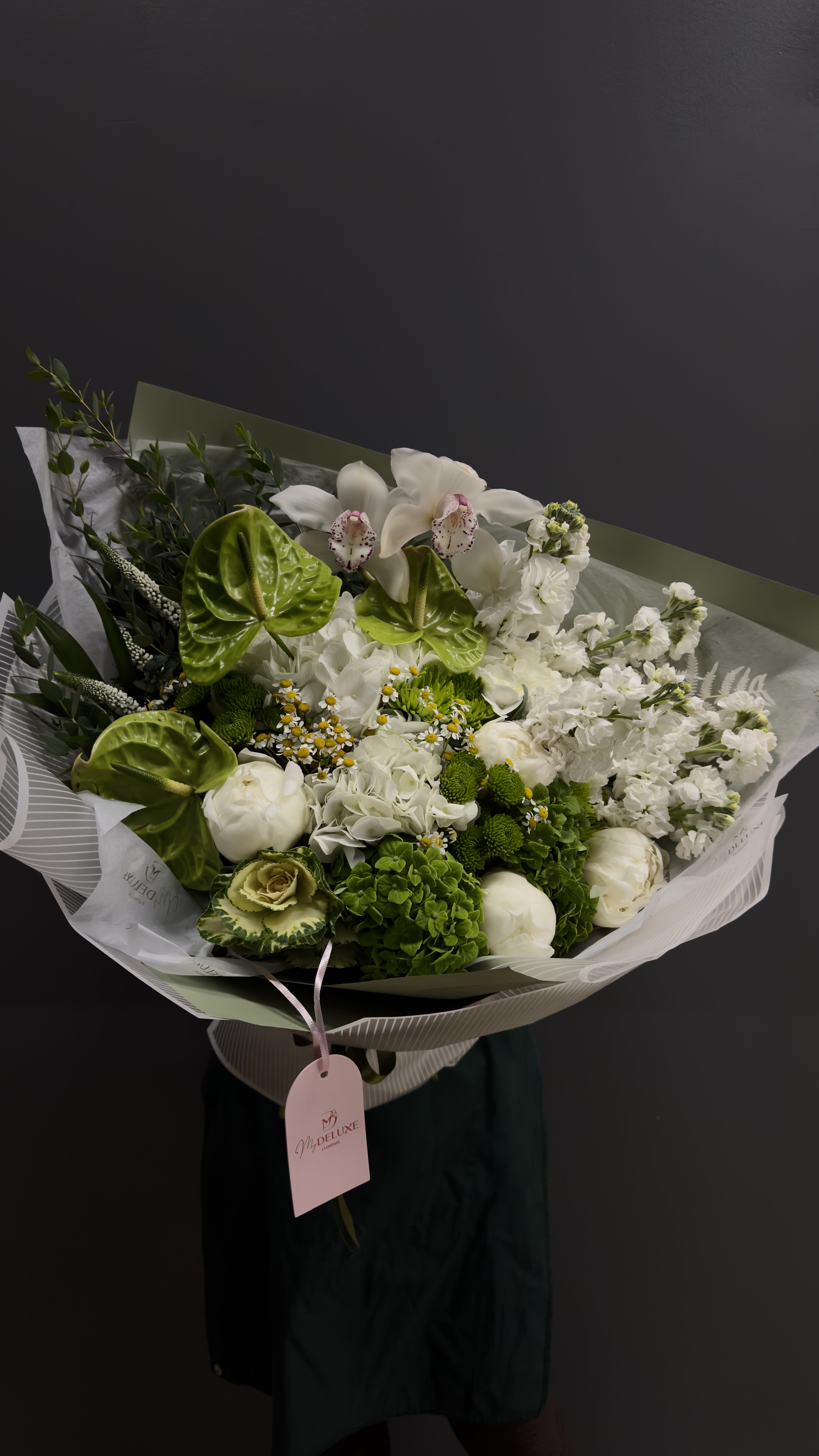 Bouquet of white flowers with bright green anthuriums and wrapped paper