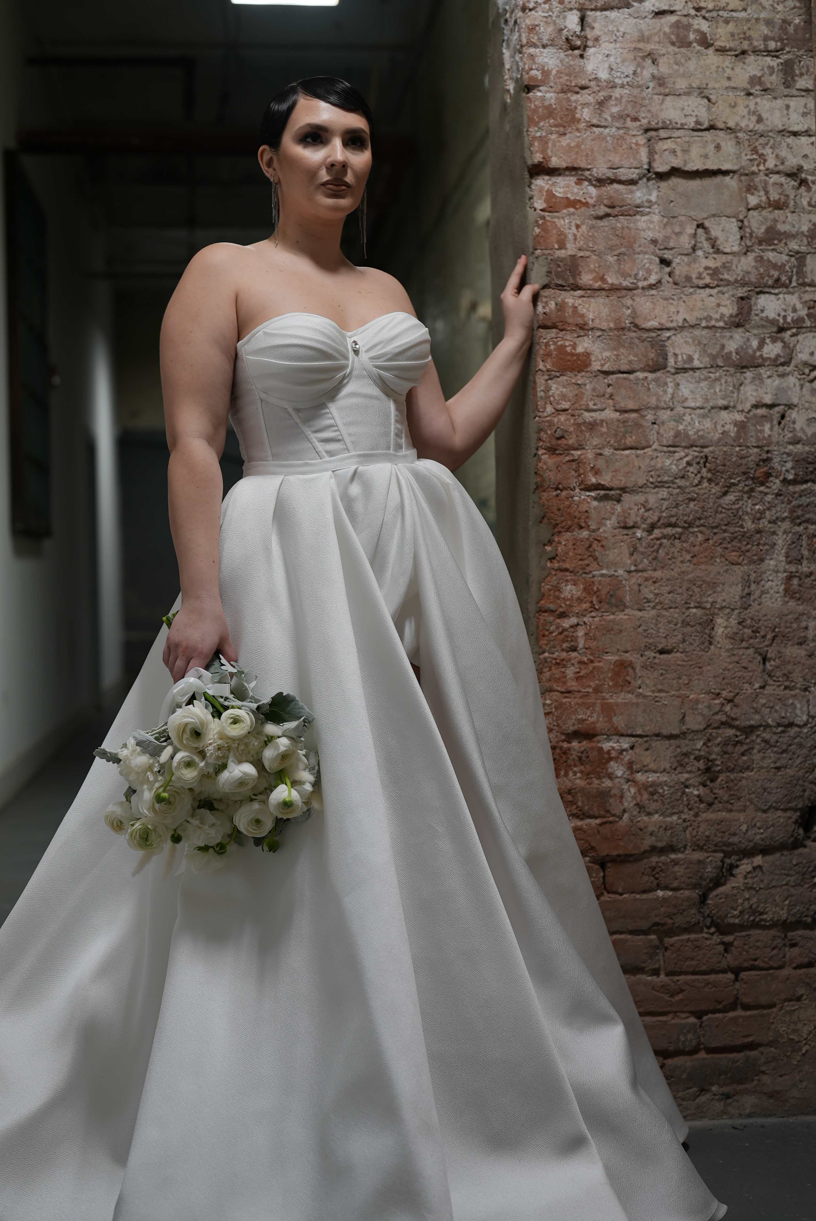 Bride in a white gown holding a white bouquet