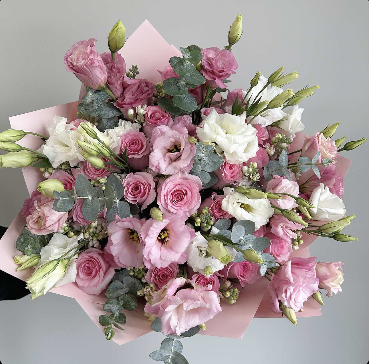 Pink and white bouquet of roses and lisianthus with eucalyptus