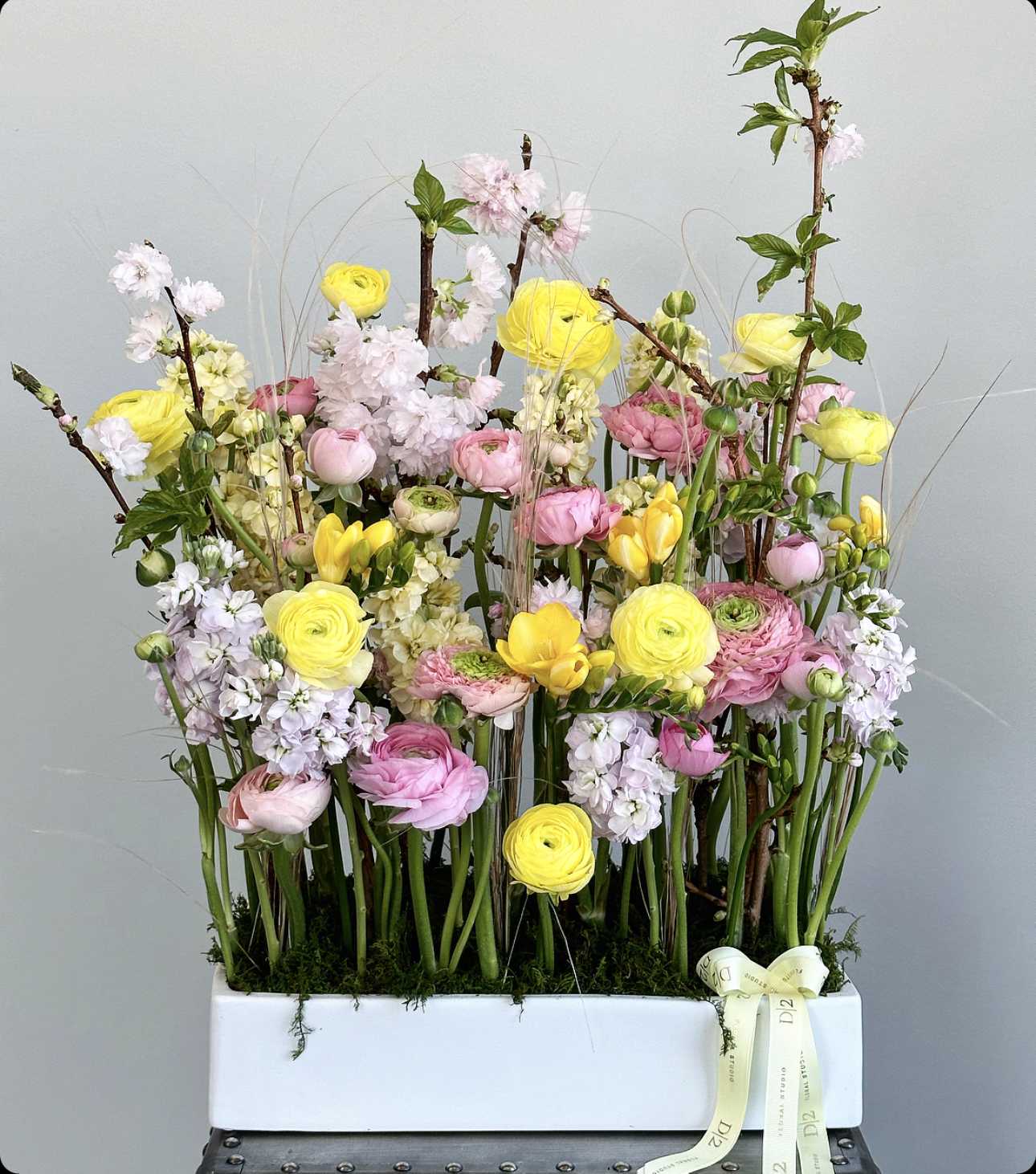 Tall mixed bouquet in a white rectangular box with pink and yellow blooms