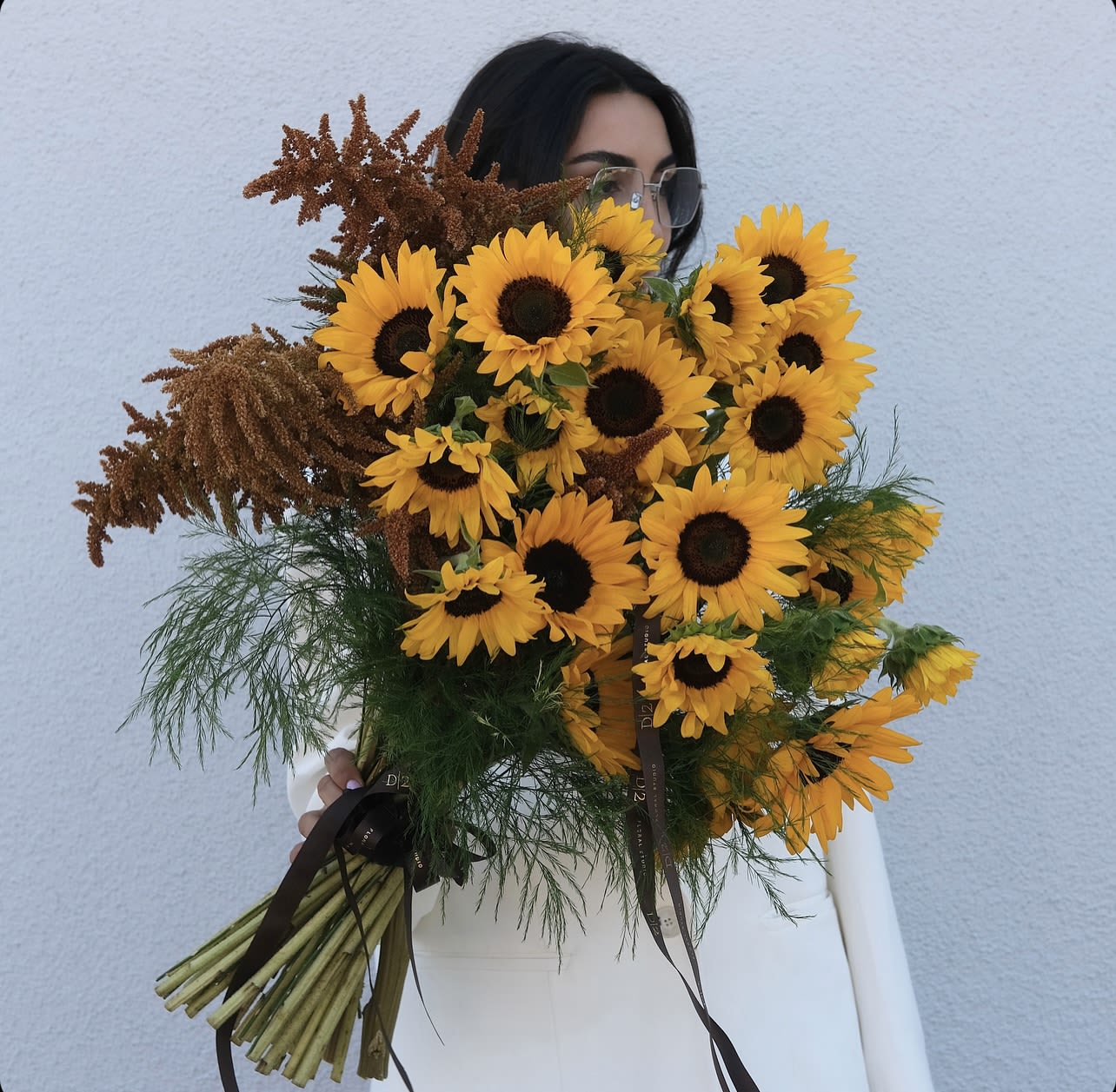 Bouquet of yellow sunflowers with brown filler flowers