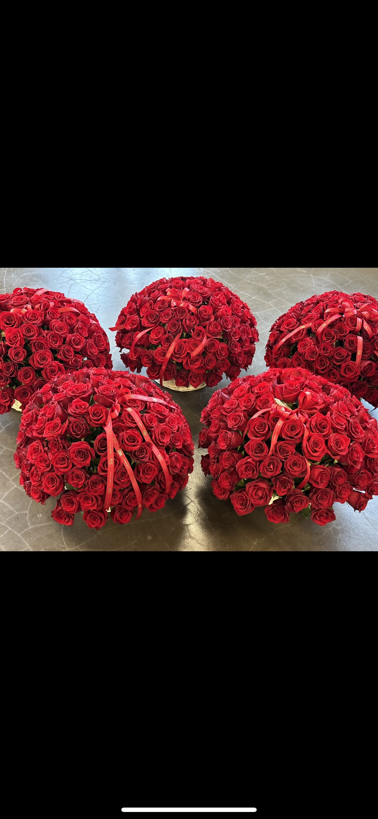 Five dome-shaped bouquets of red roses with ribbon accents