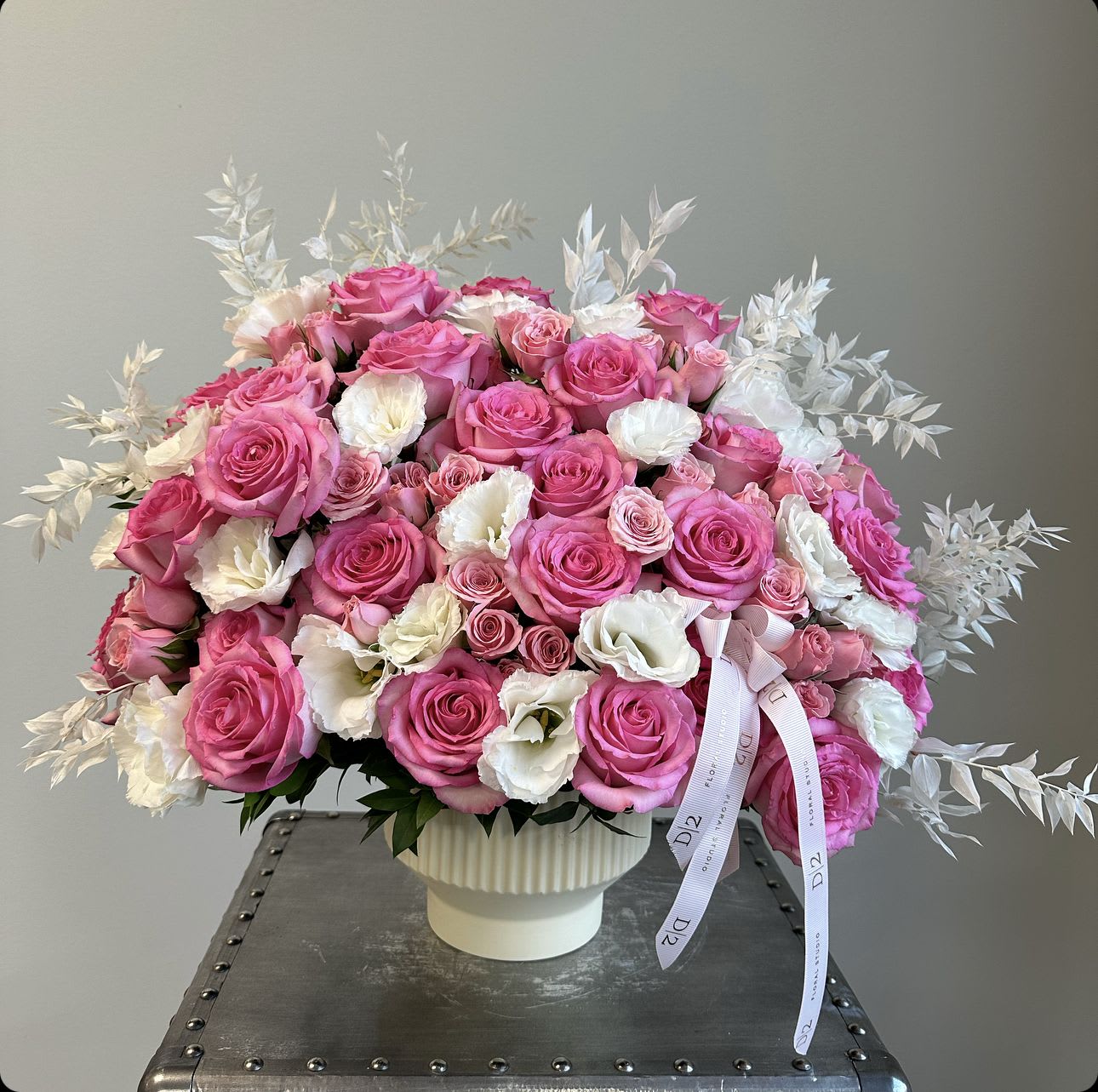 Pink and white rose bouquet in a white vase