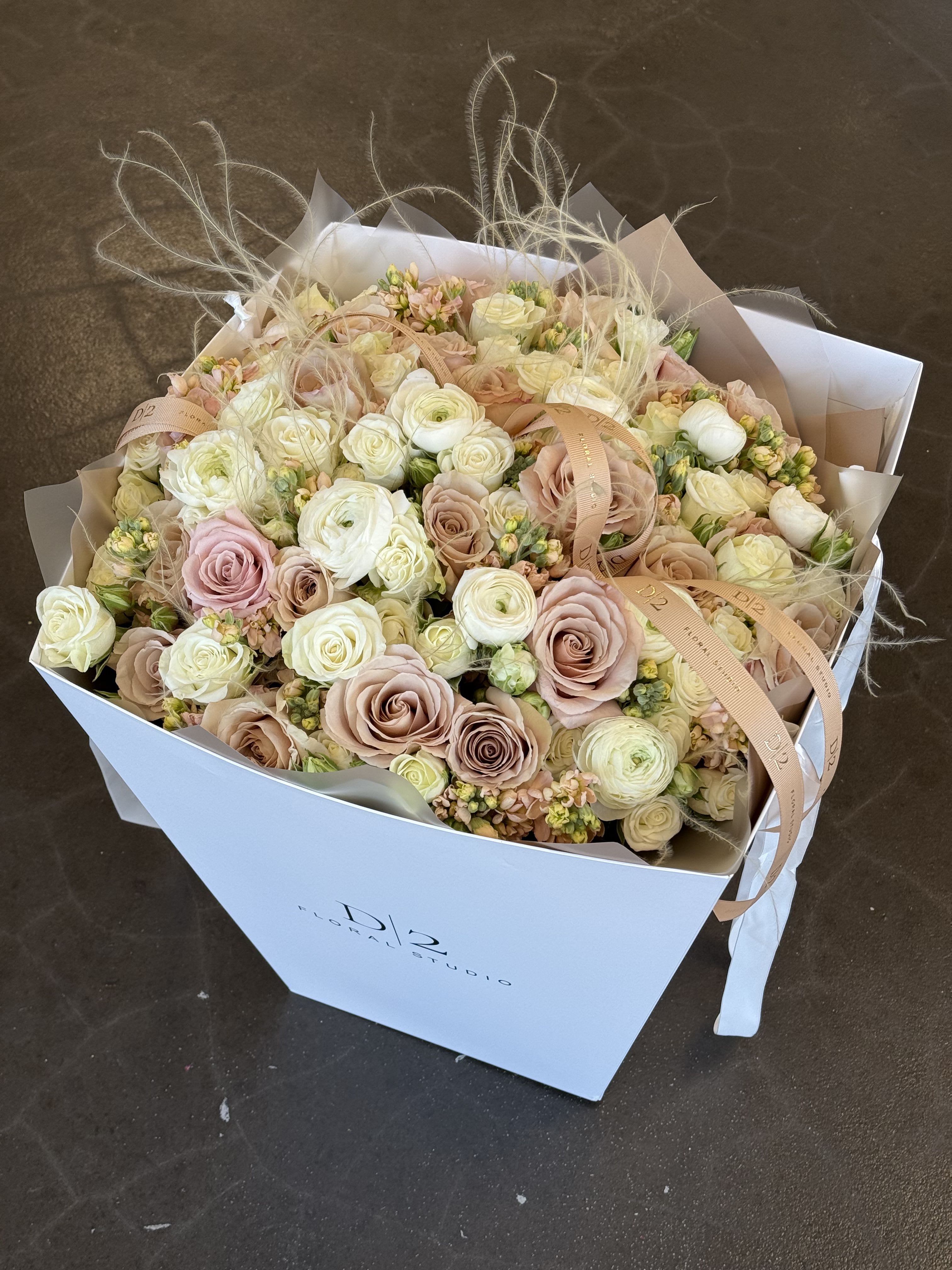 Bouquet of blush and cream roses in a white box