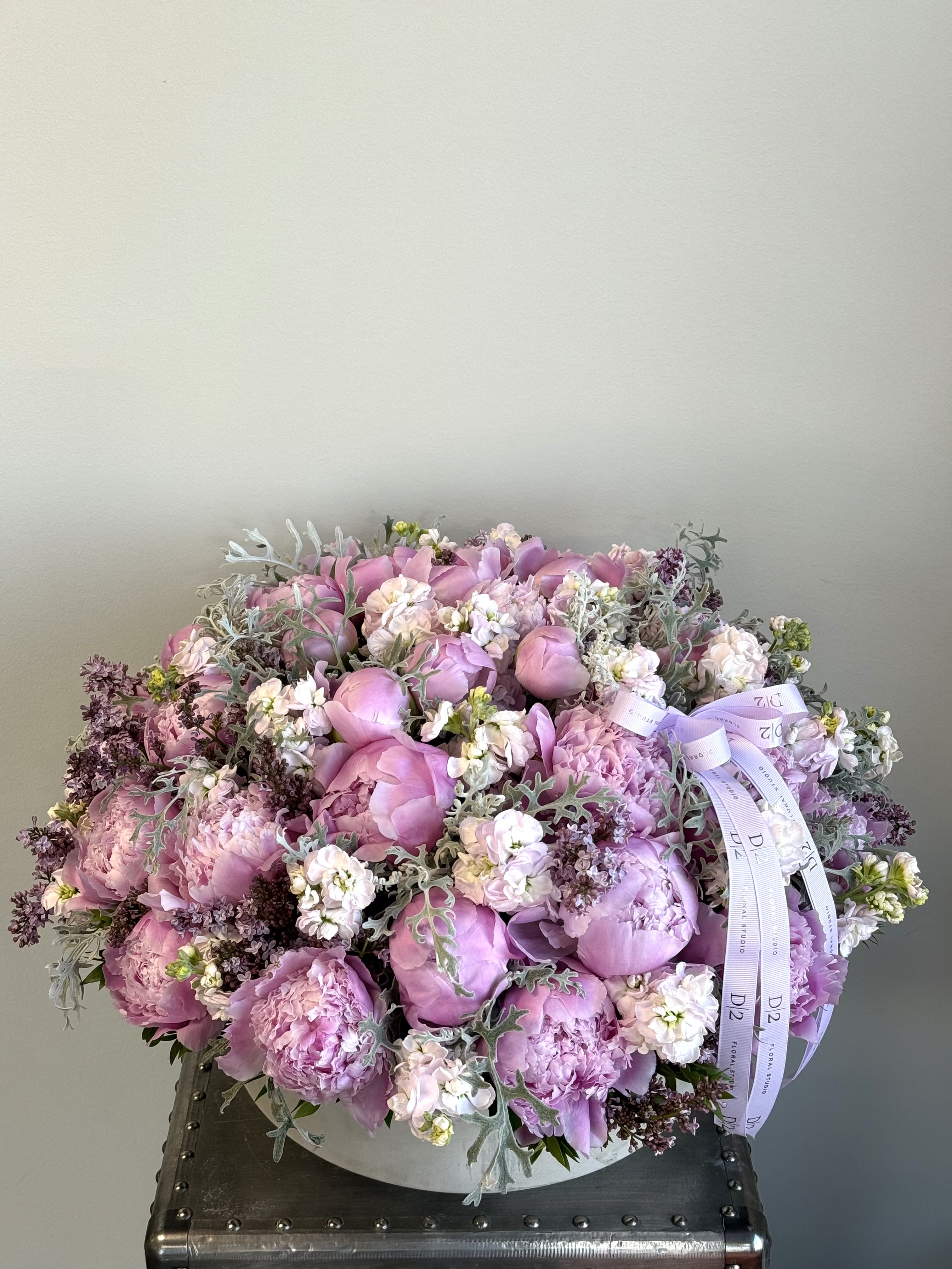 Large pink bouquet with peonies and ribbon in a round box
