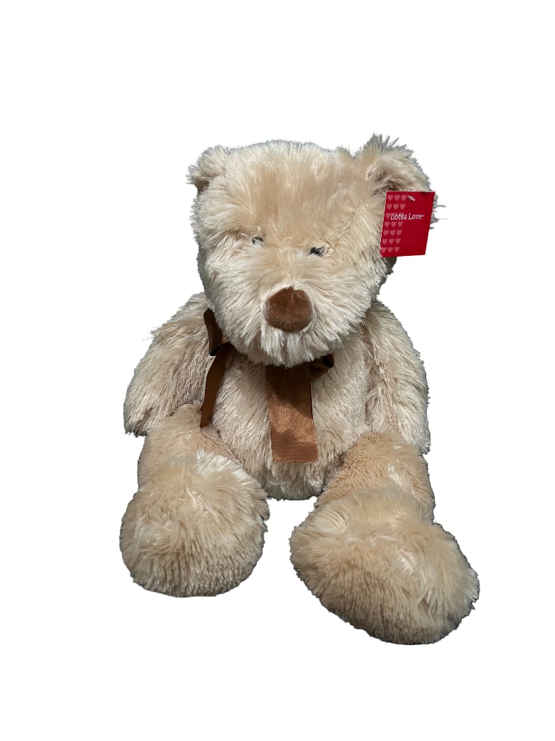 Beige teddy bear with a brown ribbon and heart tag