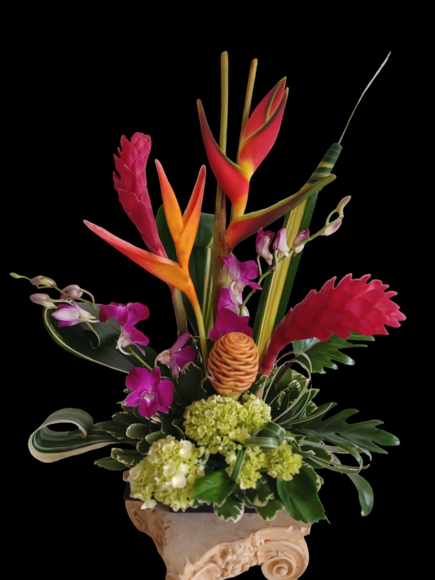 Tropical flower arrangement with orchids and bird-of-paradise in a decorative vase