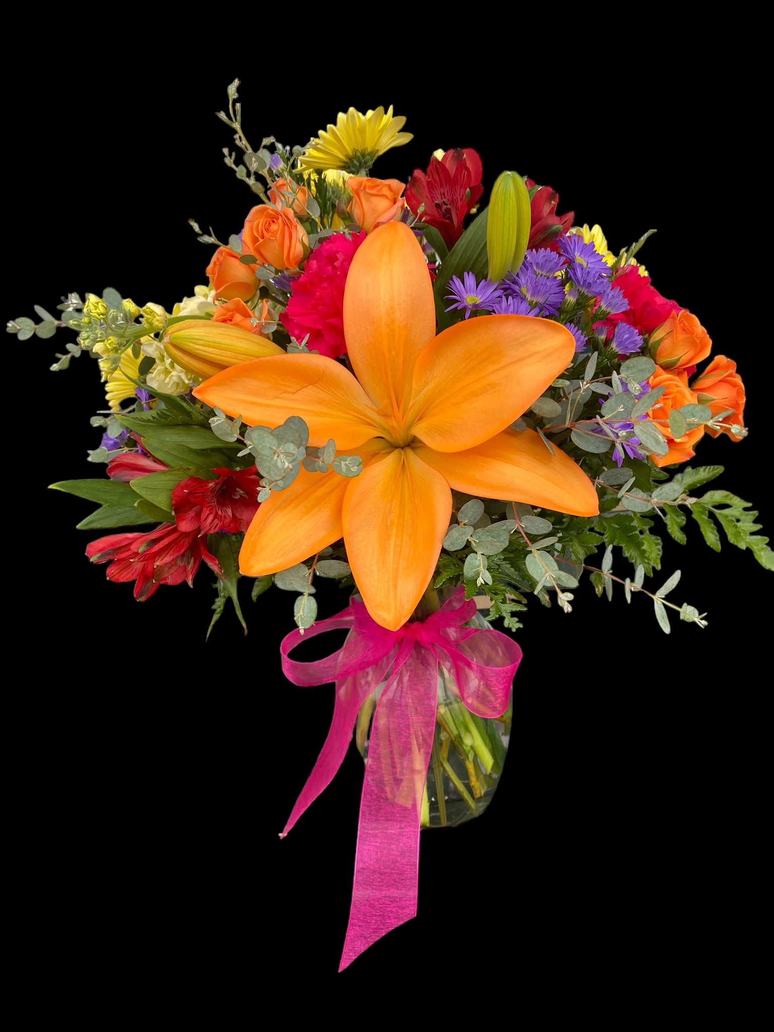 Colorful bouquet with orange lilies, roses, and purple flowers in a glass vase