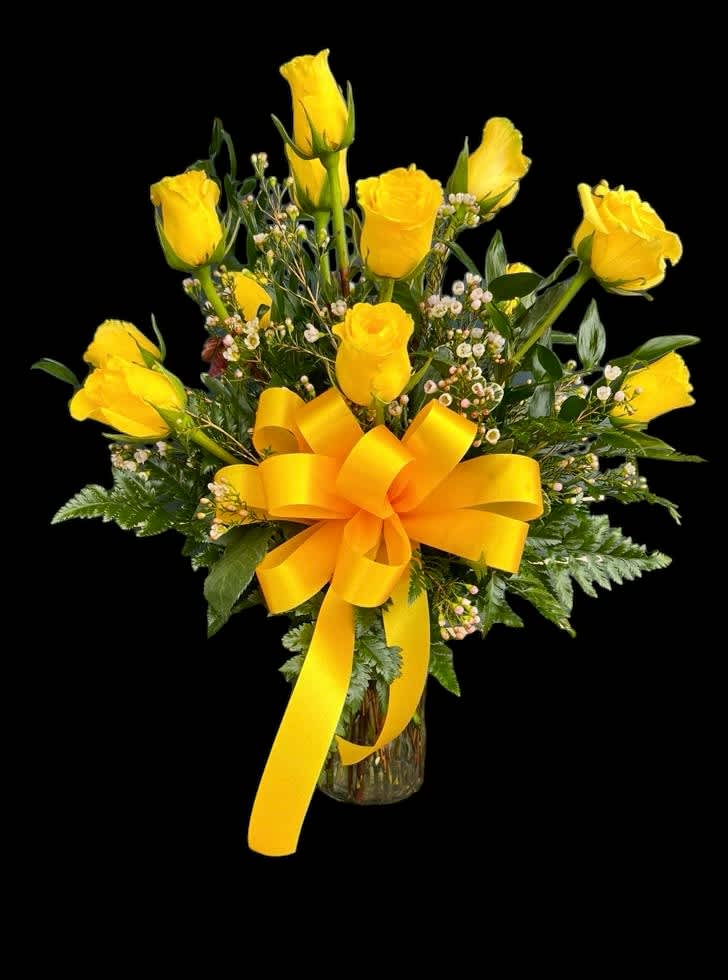 Yellow roses in a glass vase with a large yellow ribbon