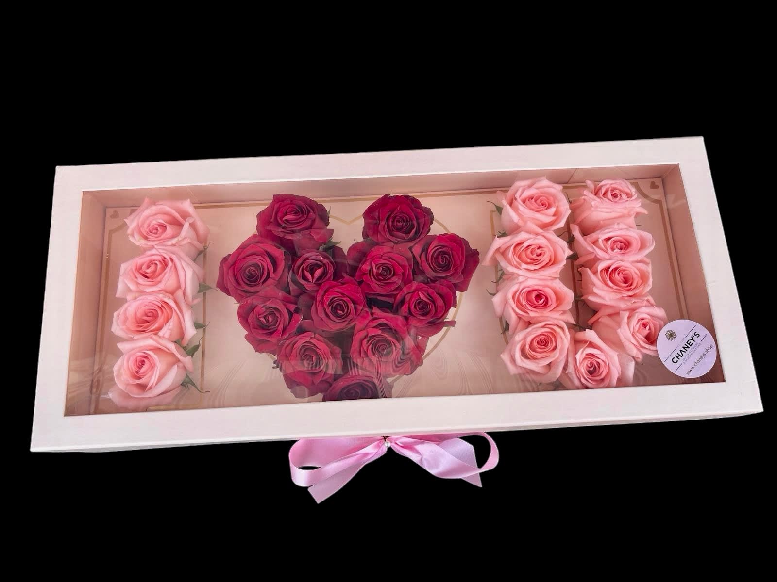 Heart-shaped rose arrangement in a white gift box with pink ribbon