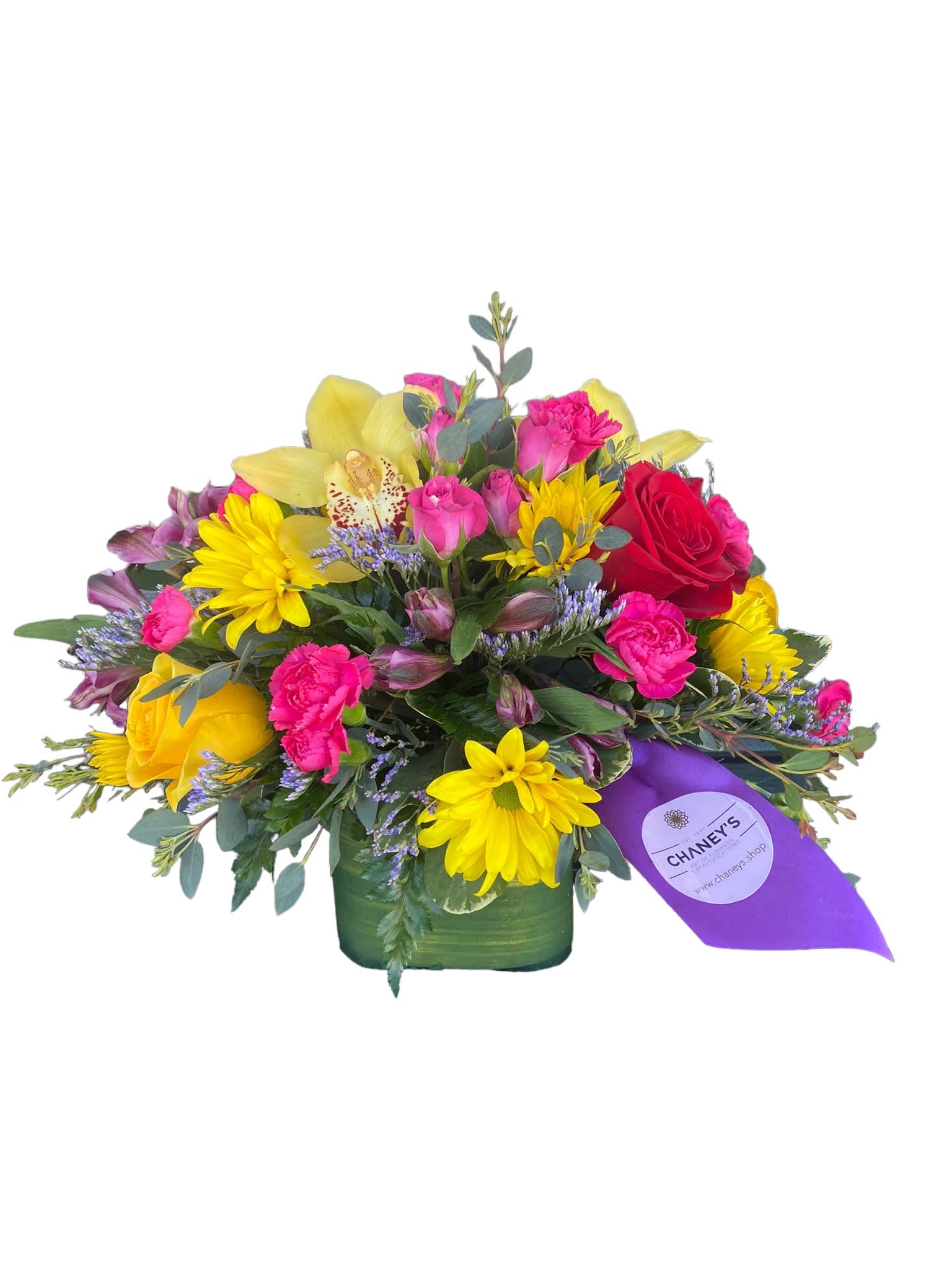 Mixed bouquet of roses, daisies, and orchids in a green vase