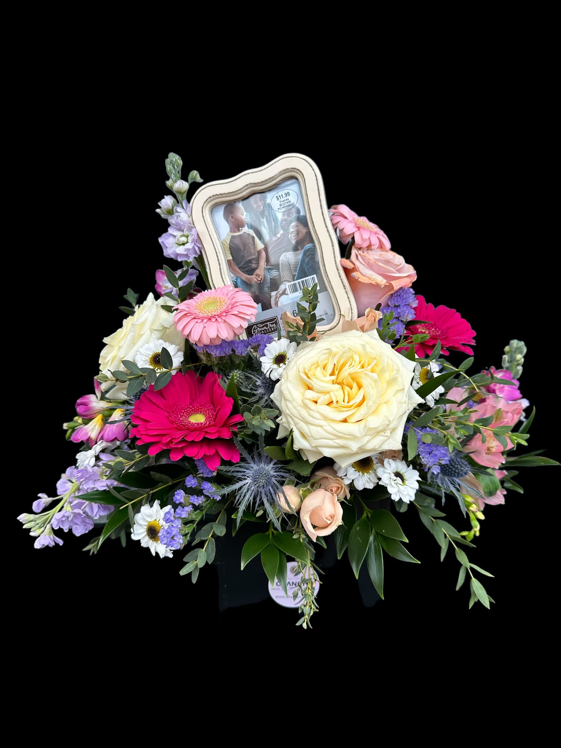 Mixed flower arrangement with a framed photo centerpiece