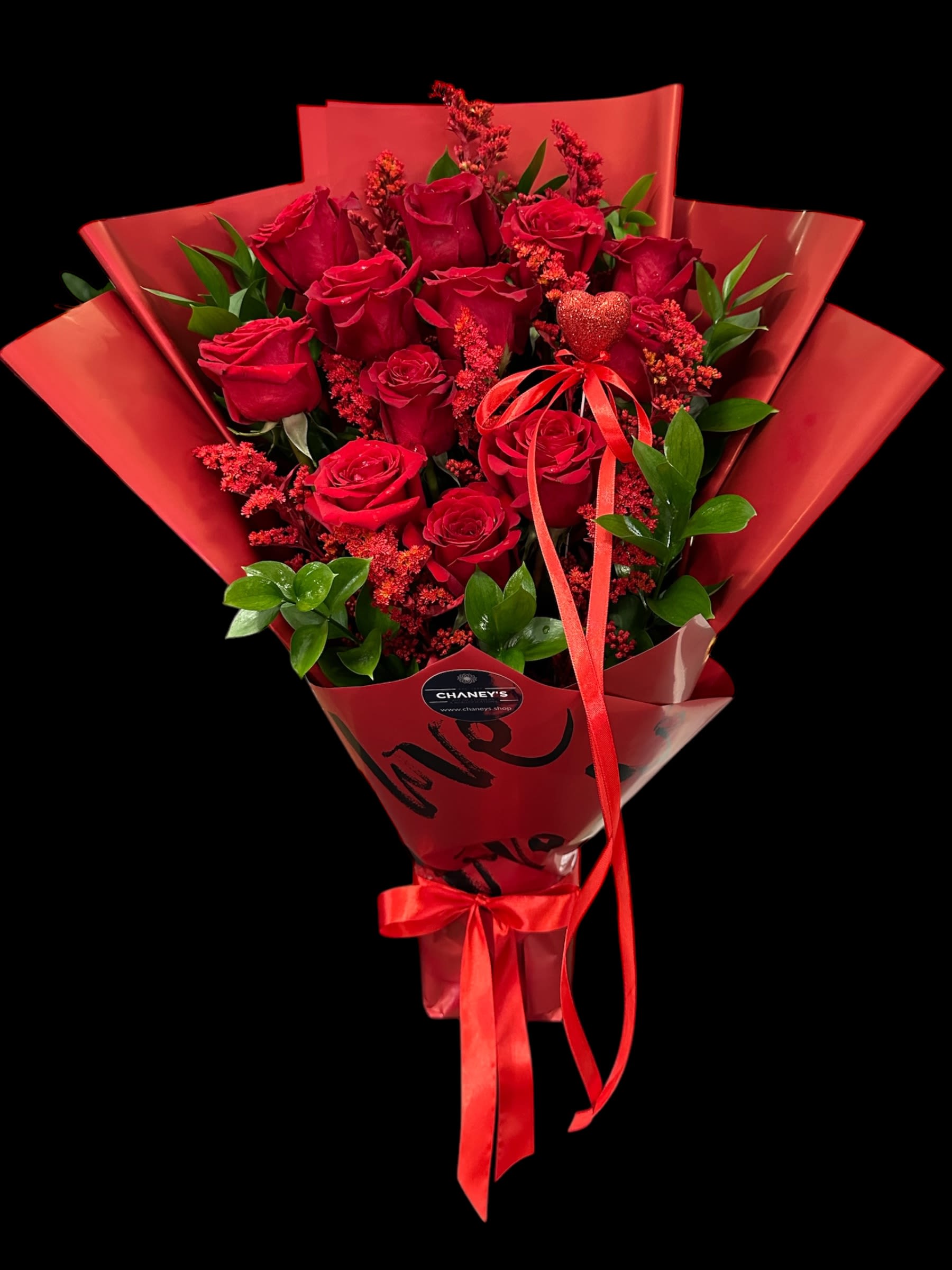 Bouquet of red roses wrapped in red paper with a ribbon