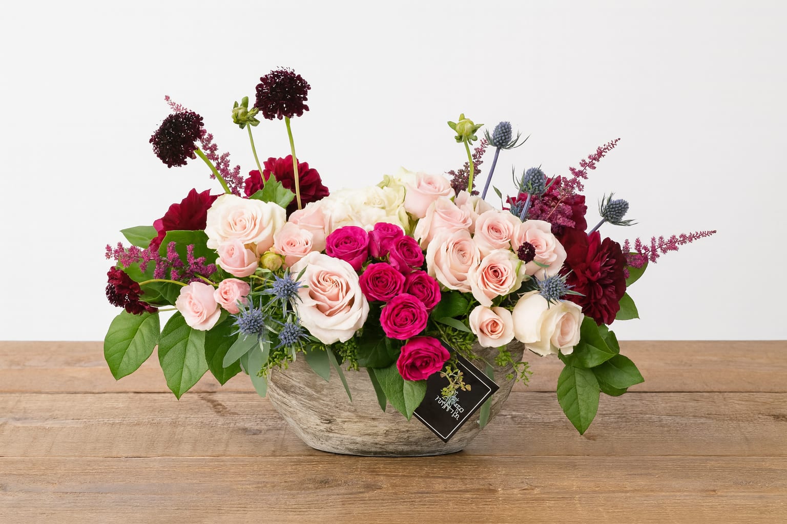 Bel Aire - FB - Introducing Bel Aire—the perfect way to impress that special someone! This elegant boat-shaped arrangement is sure to make the perfect statement. Our stunning hand-crafted piece offers an exquisite combination of roses, spray roses, and other florals that give texture and contrast in color for an unforgettable presentation. Make your next special occasion extraordinary with Bel Aire!