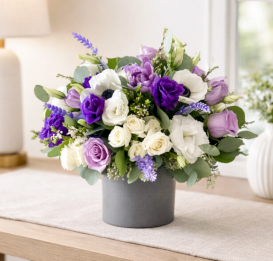 Purple and white bouquet in a gray vase