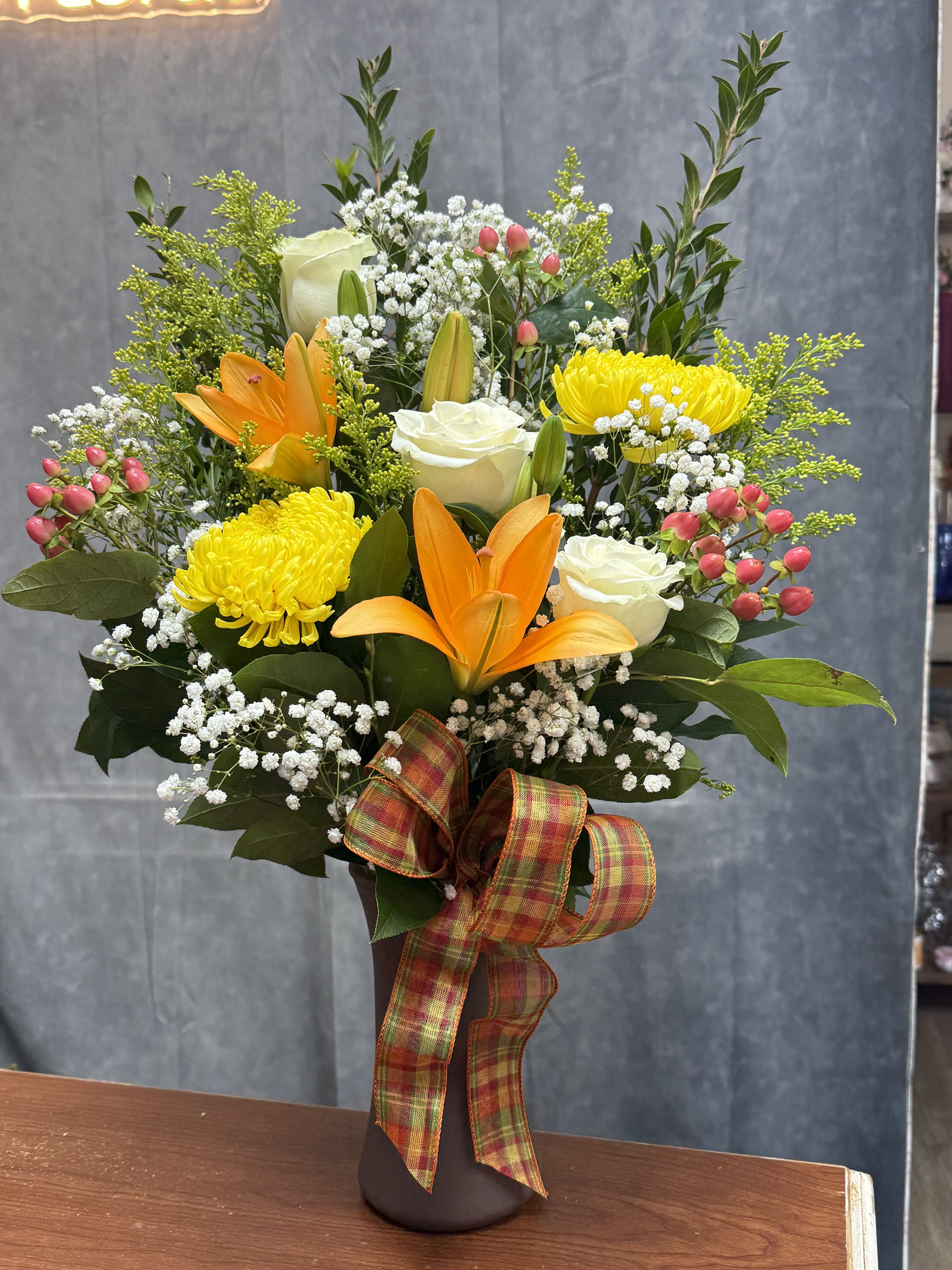 Vibrant sunshine vase - A joyful mix of orange lilies, bright yellow mums, lush hydrangeas, and roses — bursting with cheerful energy and color.