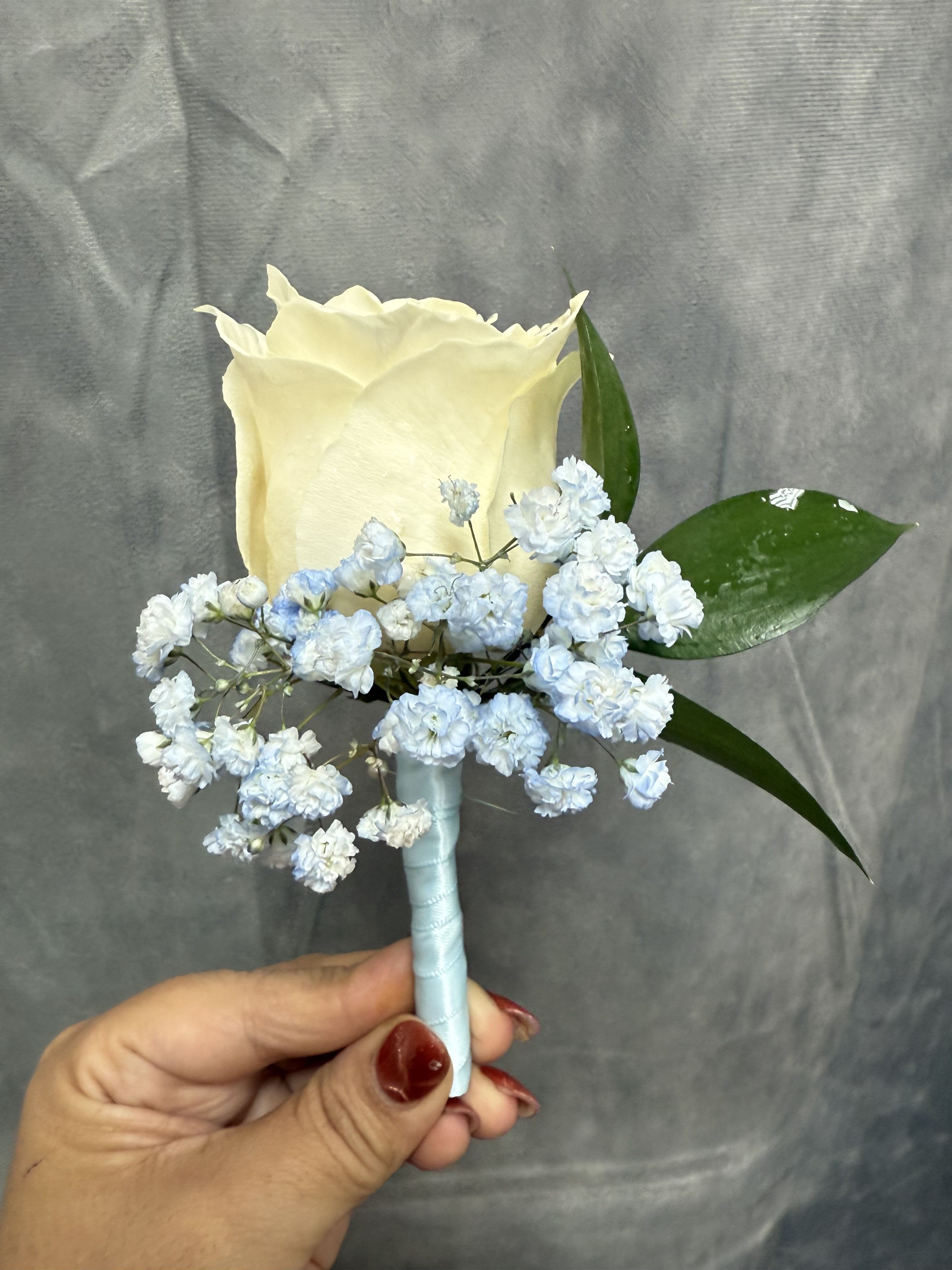 Baby blue White Rose boutonnière  - White rose boutonnière with baby blue baby breath wrapped with baby blue ribbon 