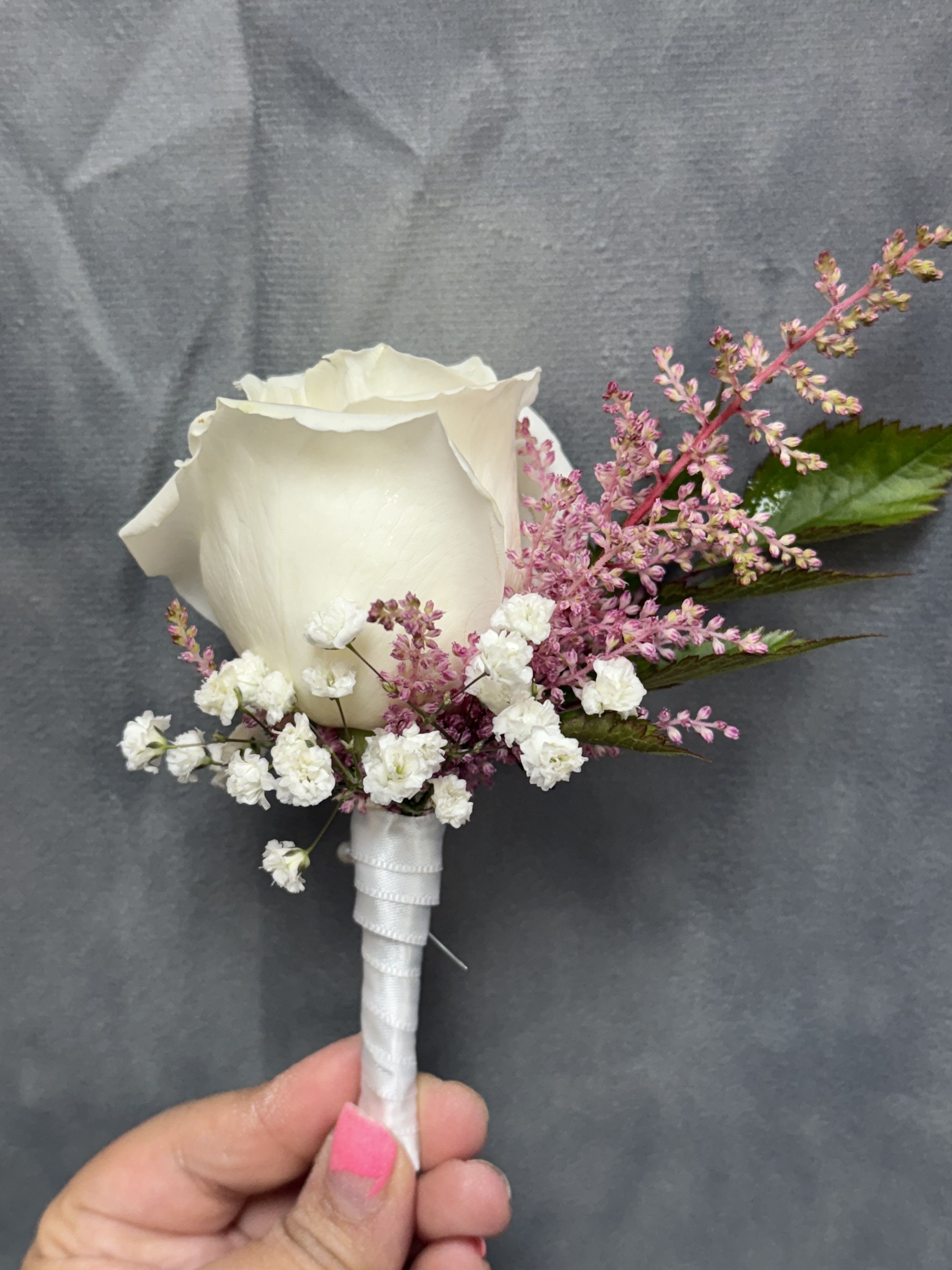 White rose pink boutonnière  - White rose with pink filler and green leaves, stems wrapped in white ribbon