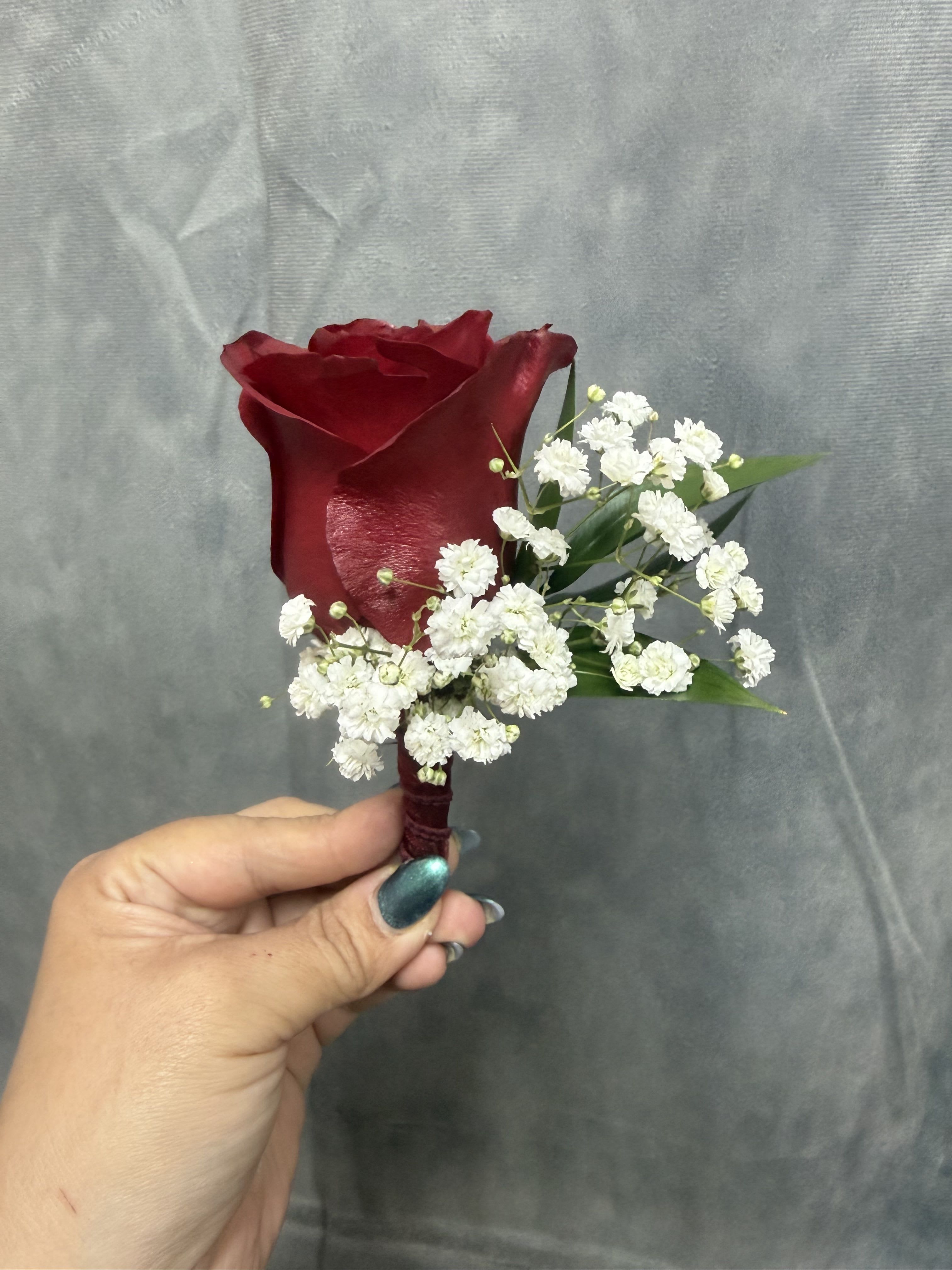 Red rose boutonnière  - Deep red rose with white filler and green leaves beautifully wrapped 