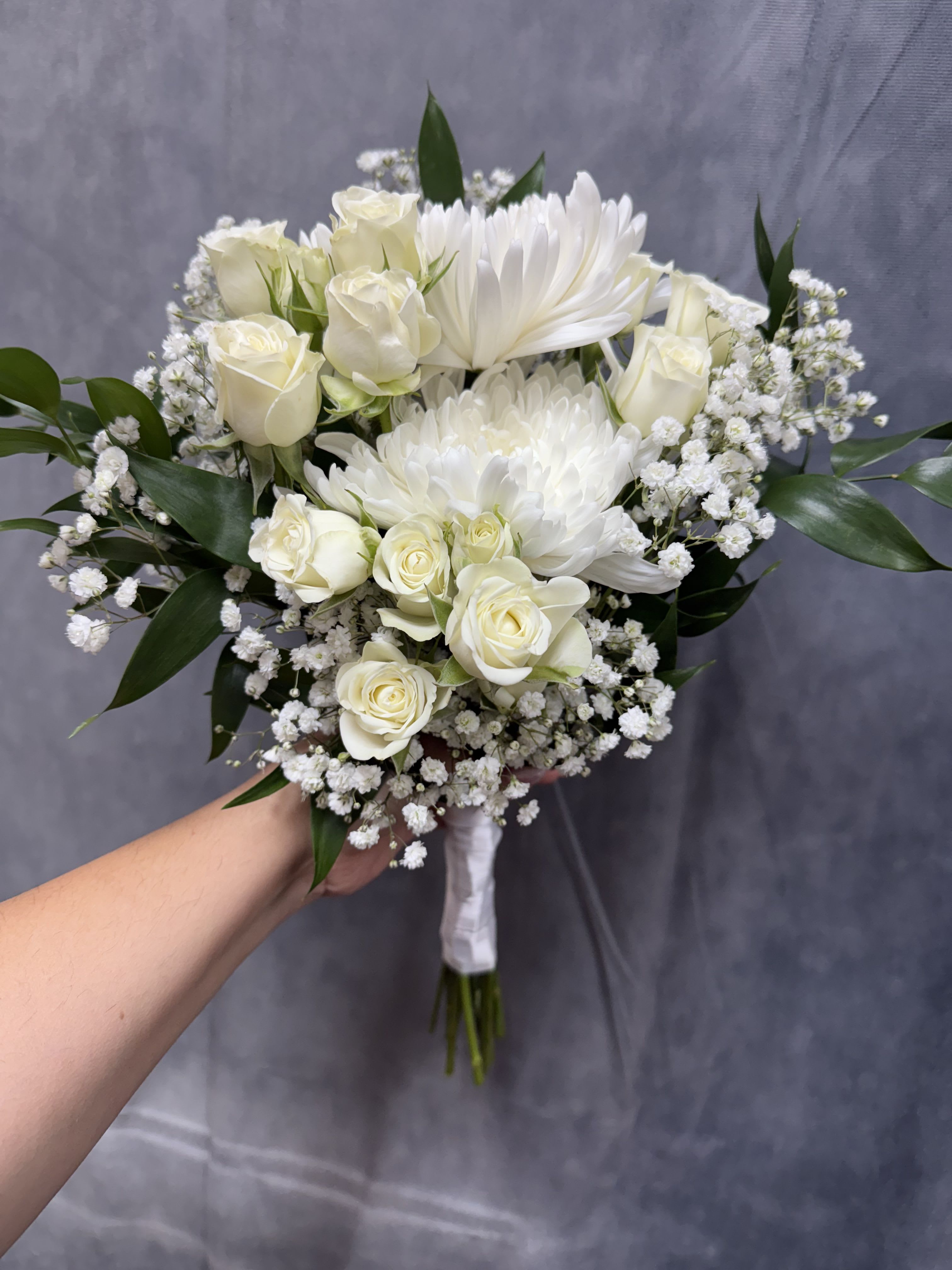 Mix white prom bouquet  - White roses and large white chrysanthemums with baby's breath and greenery , hand-tied with white ribbon for an elegant, calm bouquet