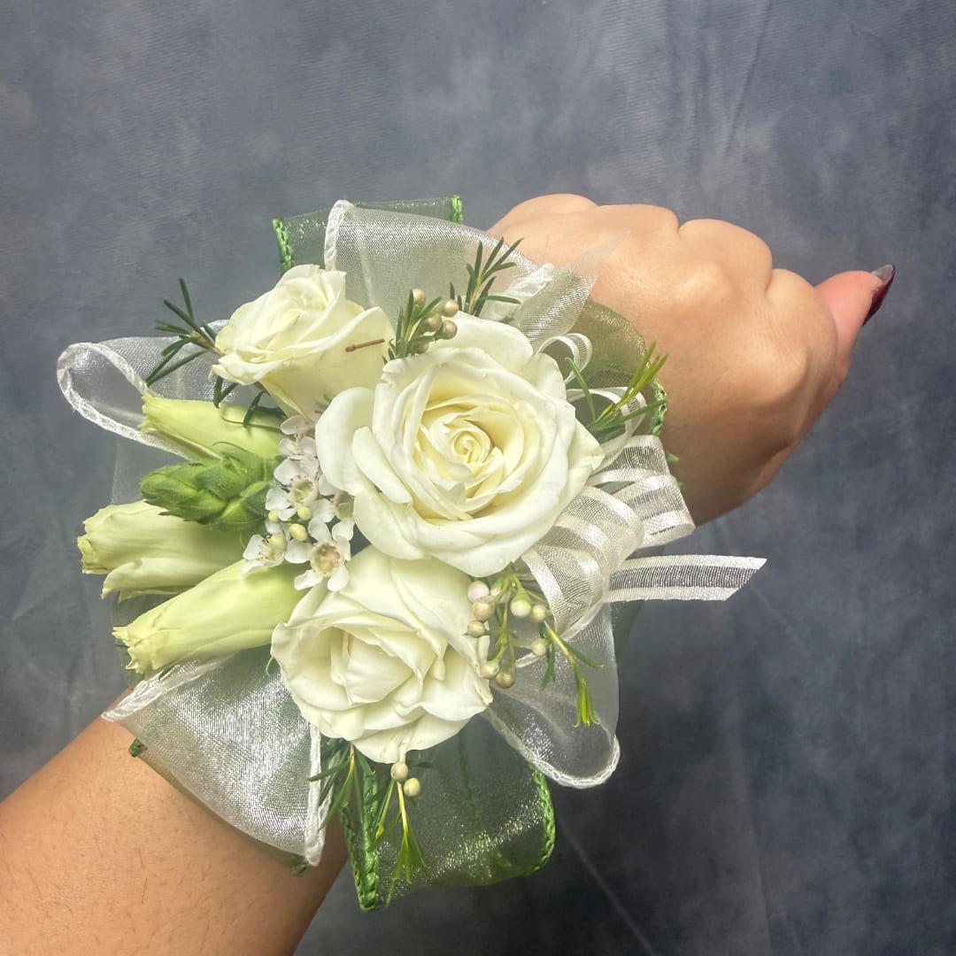 White rose wrist corsage with ribbon and green accents