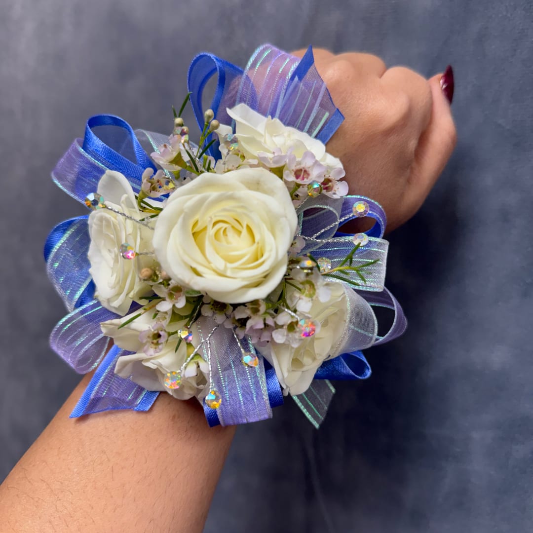 White rose wrist corsage with blue ribbon and small blossoms