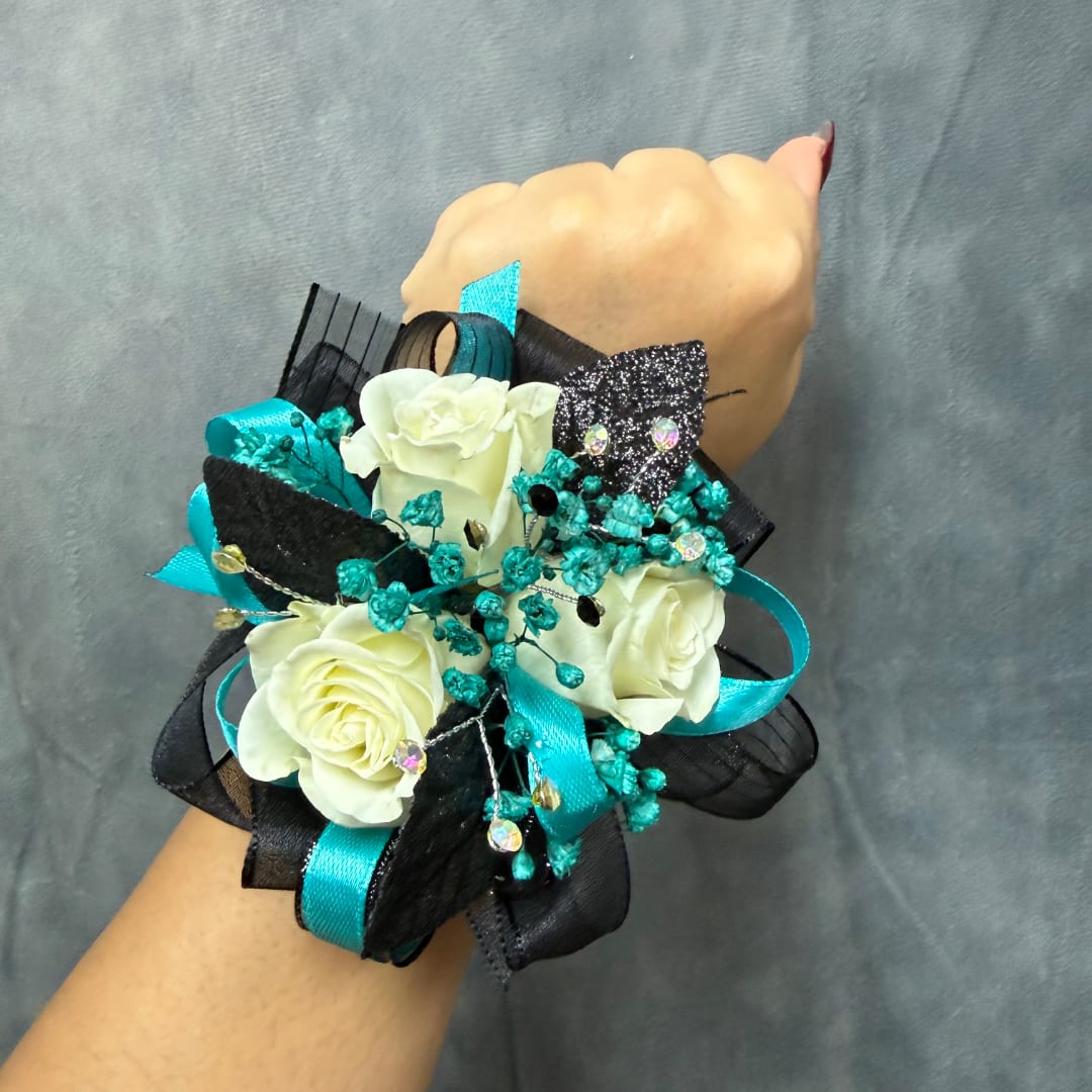 Wrist corsage with white roses, turquoise ribbon, and black accents
