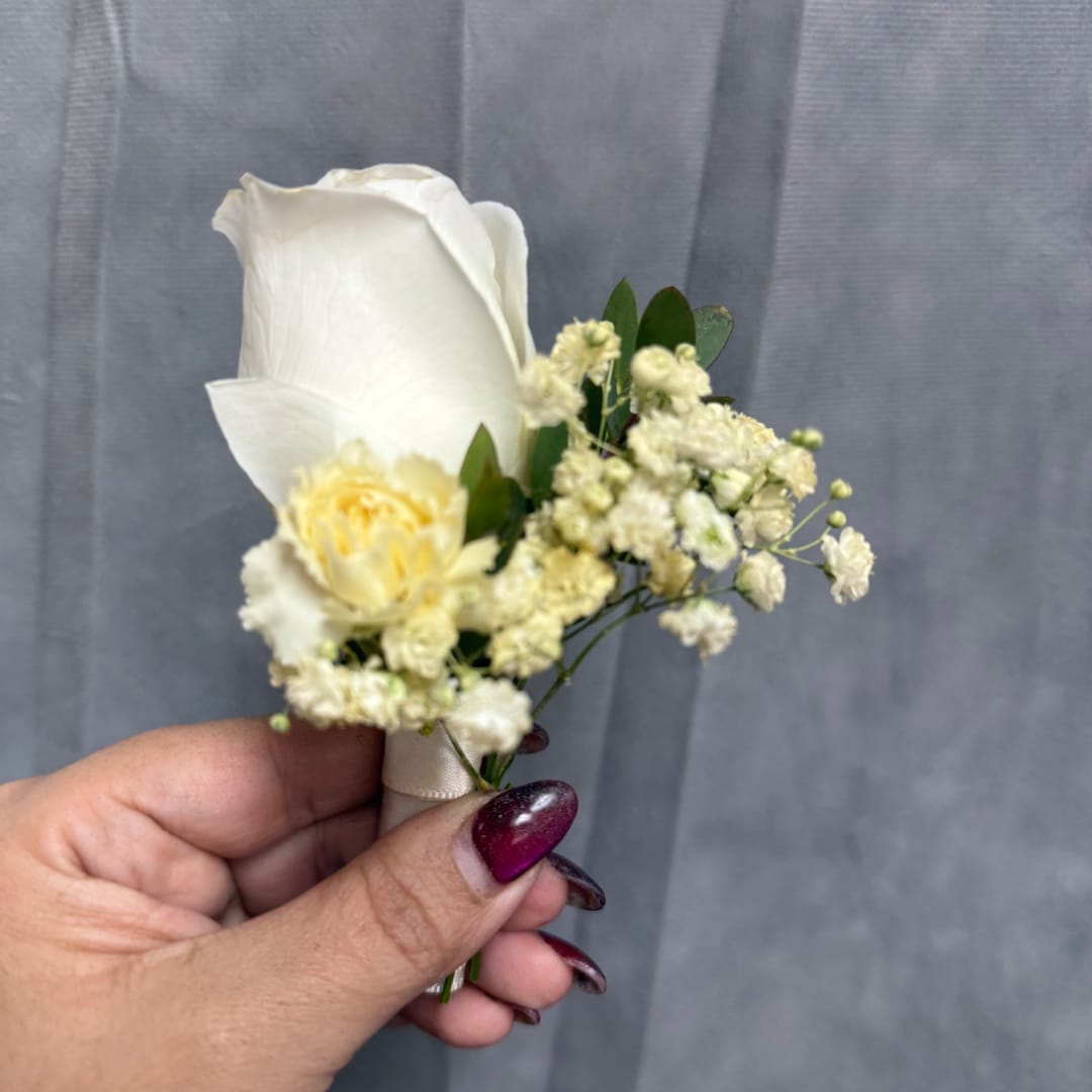 White rose boutonniere with small cream filler flowers