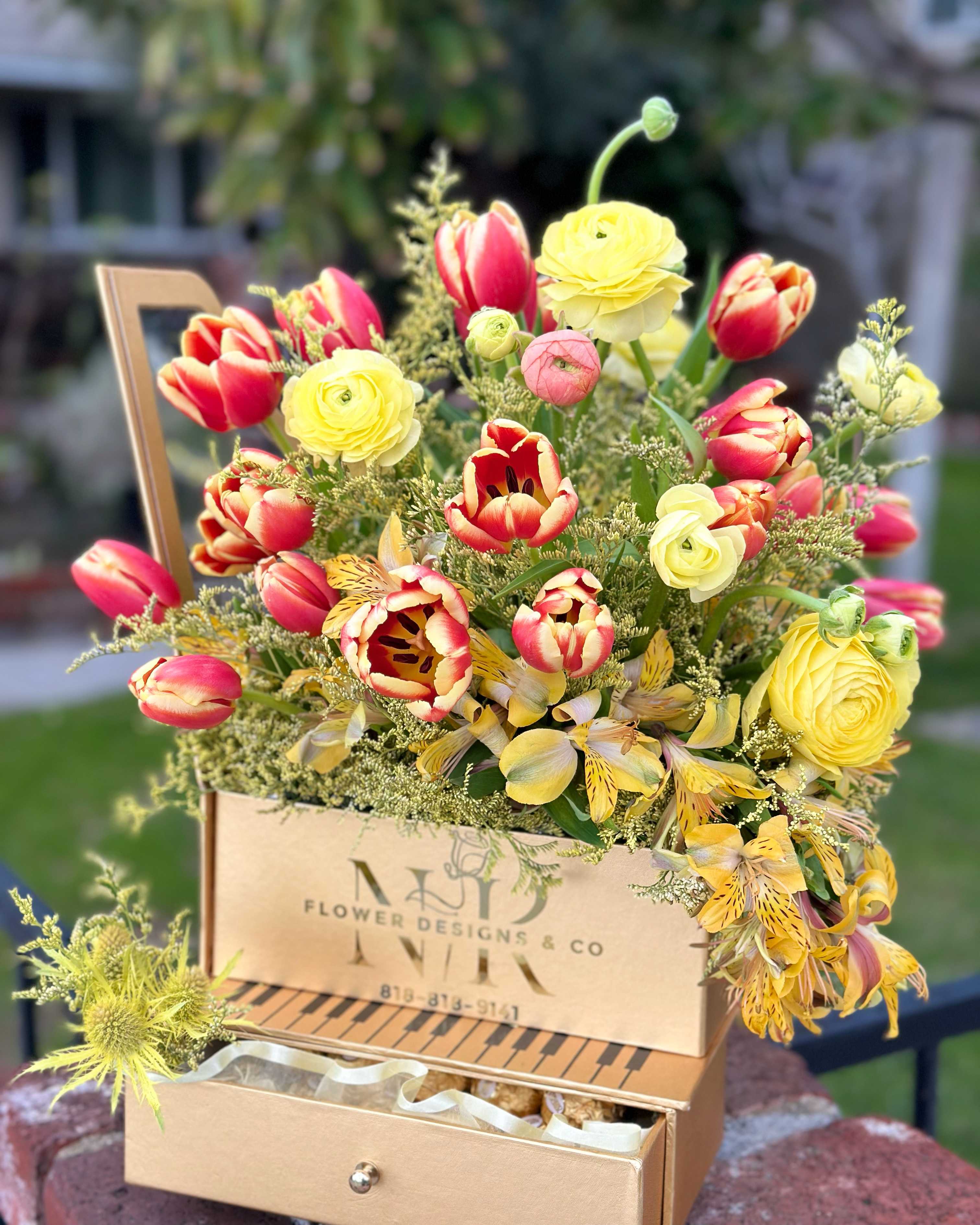 Bright Melody! - Bright and Elegant combination of Tulips, Ranunculus, and Iris flowers are put together to cheer up and congratulate on a happy note!