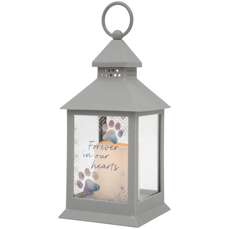 Gray memorial lantern with a candle and "Forever in our hearts" text