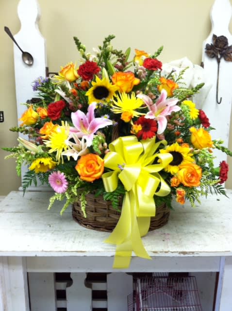 Mixed flower basket with a yellow ribbon bow