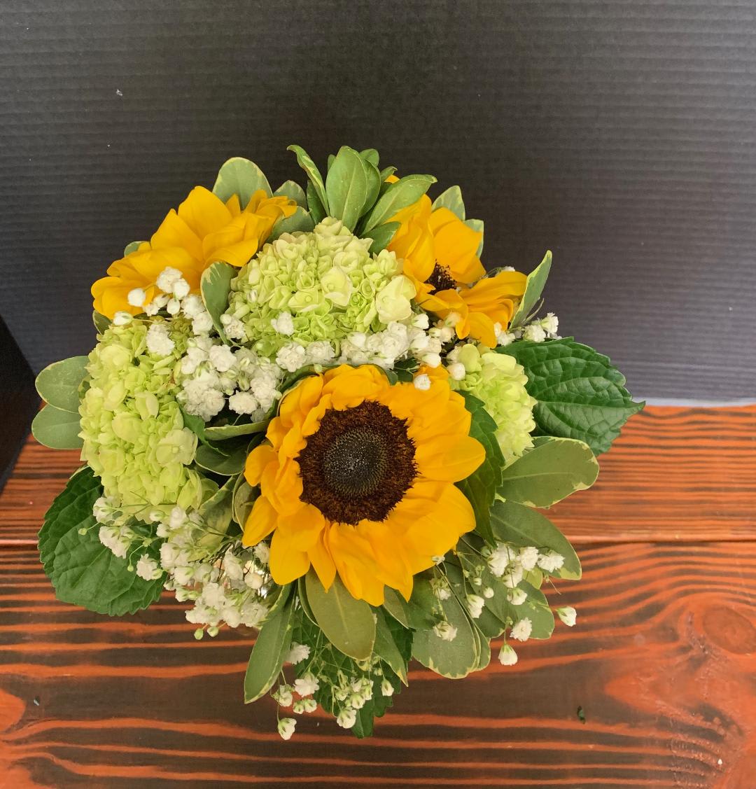 Bouquet of yellow sunflowers with green hydrangeas and white filler flowers